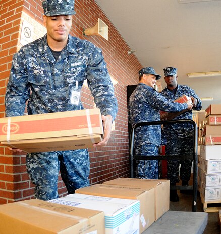 Ship’s Serviceman 3rd Class Kevin Simpson (left), Ship’s Serviceman 2nd Class Henry Polanco and Ship’s Serviceman 2nd Class Maurice Monroe help unload more than 20 pallets of frozen foods, bread and baked goods during a stores on-load at Joint Base Charleston-Weapons Station Galley, March 17. SH3 Simpson, SH2 Palonco and SH2 Monroe are attached to Naval Support Activity. (U.S. Navy photo/Mass Communication Specialist 1st Class Jennifer R. Hudson)
