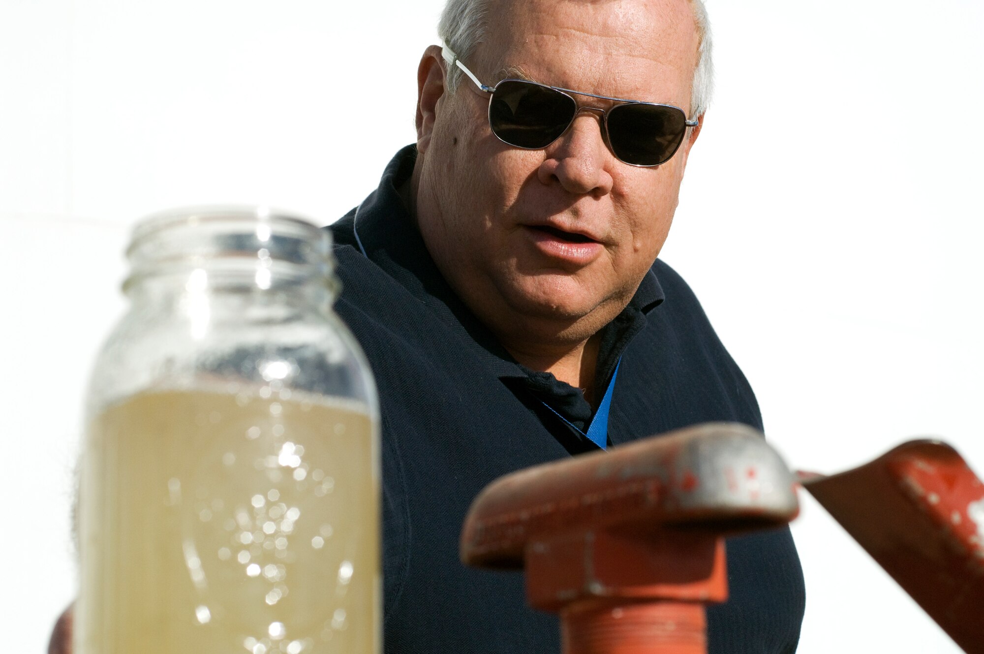 Cliff Cunningham, 95th Mission Support Group fuels testing and technical advisor, checks for water in a sample of JP-8 jet fuel taken from a bulk fuel storage tank on base. (Air Force photo by Kate Blais)