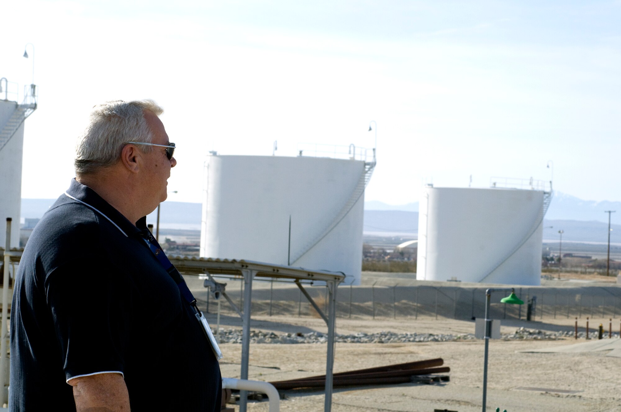 From atop a hill between Forbes Avenue and Lancaster Boulevard, Cliff Cunningham, 95th Mission Support Group fuels testing and technical advisor, surveys the base’s bulk fuel storage area. For 10 years, Mr. Cunningham has worked with the Edwards fuels system, ingeniously working to keep the 1950s-era system functioning. (Air Force photo by Kate Blais)