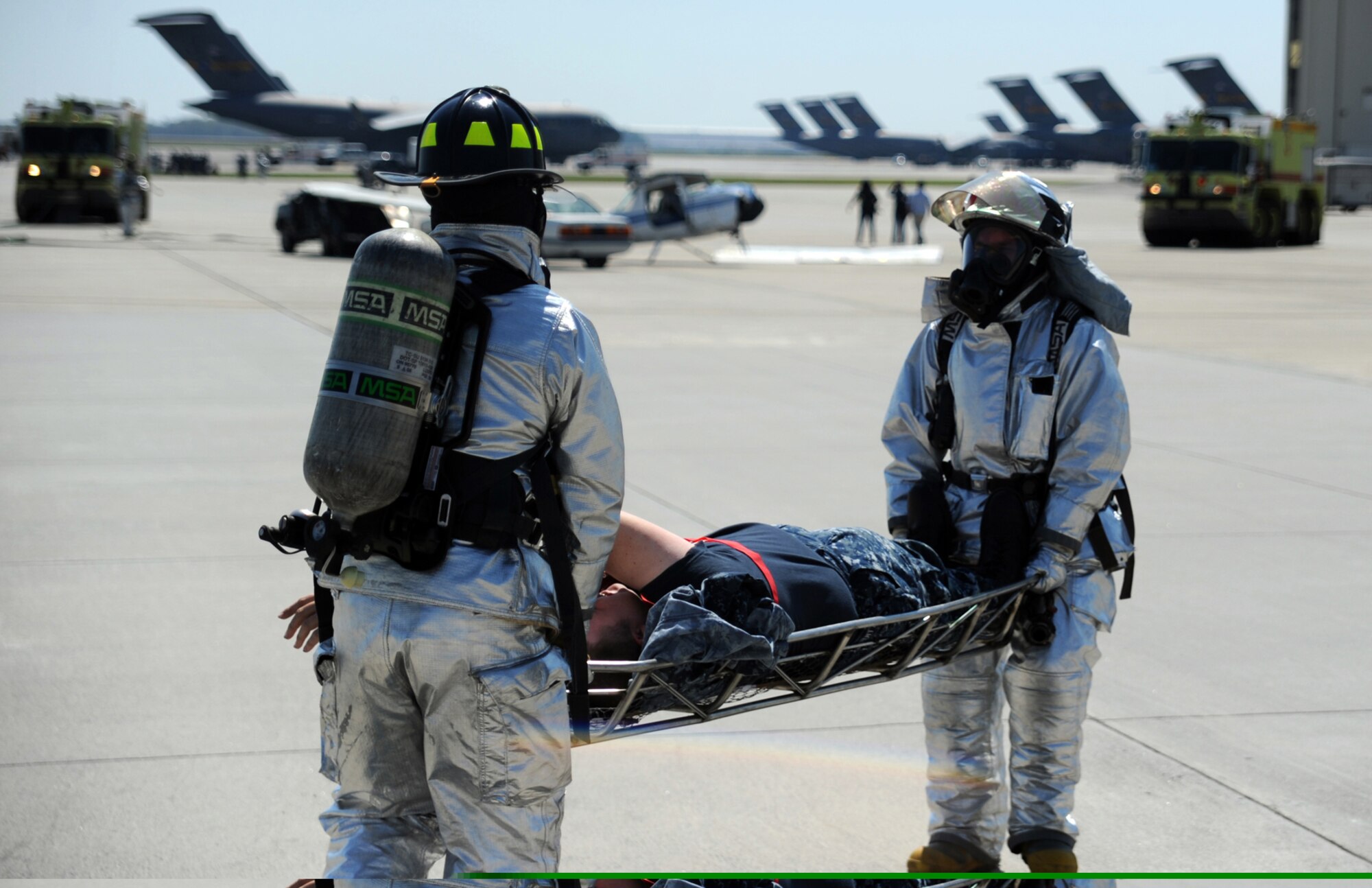 Emergency responders from the 628th Civil Engineer Squadron carry a simulated victim to the onsite triage during a Major Accident Response Exercise March 22, 2011 on Joint Base Charleston, S.C. The MARE is a necessary step to prepare all Joint Base Charleston members for the upcoming 2011 Air Expo. The exercise is used to help test and train the supporting agencies who would respond in case of an emergency. (U.S. Air Force photo/Senior Airman Timothy Taylor) (Released)