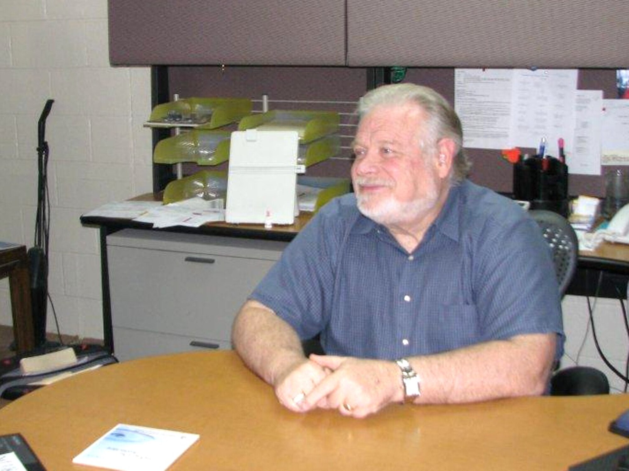 Dr. Bill Vail, Edwards Employee Assistance Program and licensed Marriage and Family Therapist, takes a moment to chat with a client. The EAP offers several ways of communicating, in person, by phone or some issues can be resolved through email. (Air Force photo by Diane Betzler)
