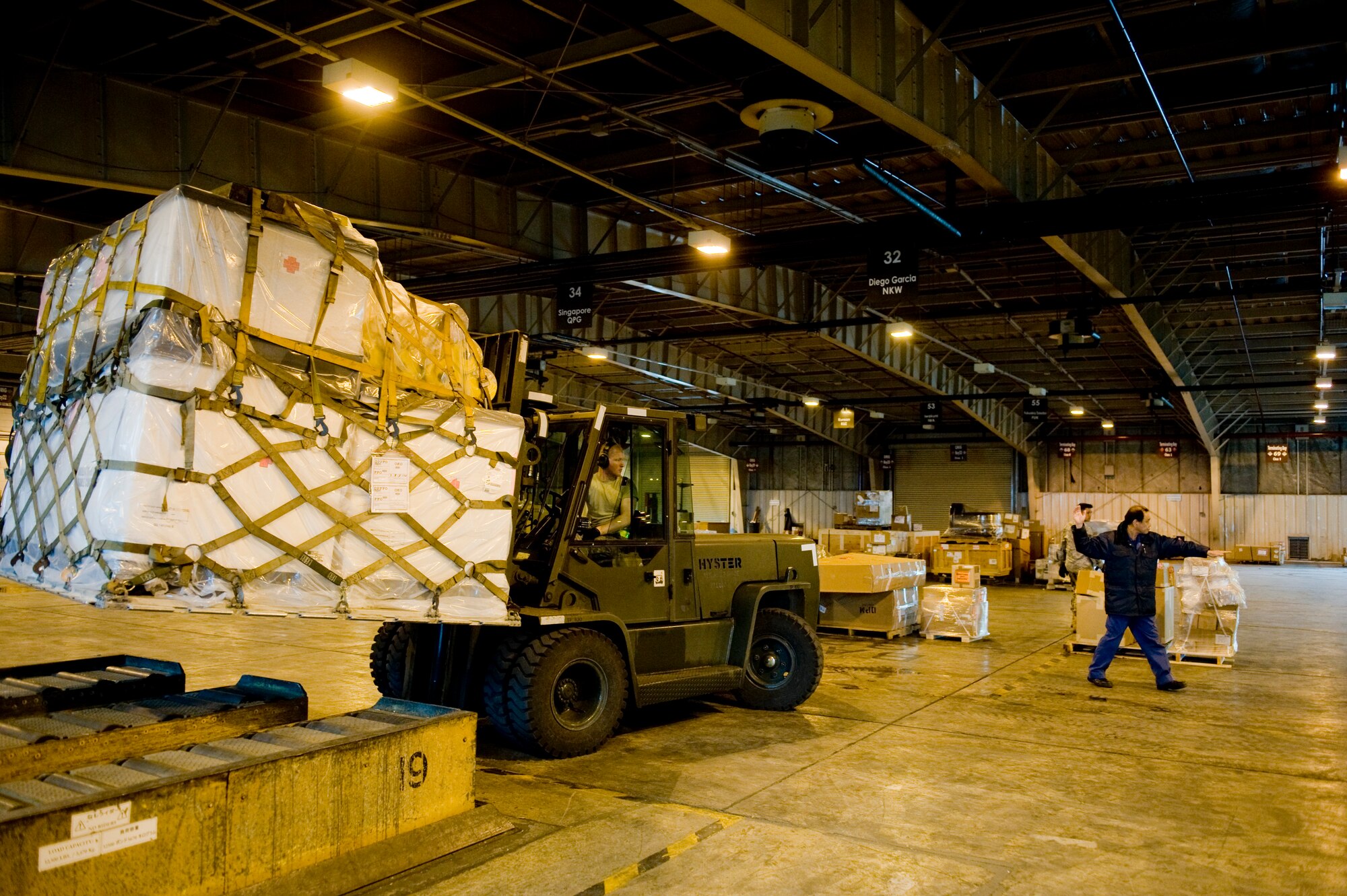 YOKOTA AIR BASE, Japan -- Mr. Hidenano Nakanishi, 730th Air Mobility Squadron (AMS), backs up a forklift with medical supplies for Operation Tomodachi here March 23. The 730th AMS has been storing and delivery en-route cargo to aircrafts and vehicles in support of humanitarian assistance. The cargo that the 730th AMS processed includes water, food, medical supplies and other basic needs. (U.S. Air Force photo/Staff Sgt. Jonathan Steffen)