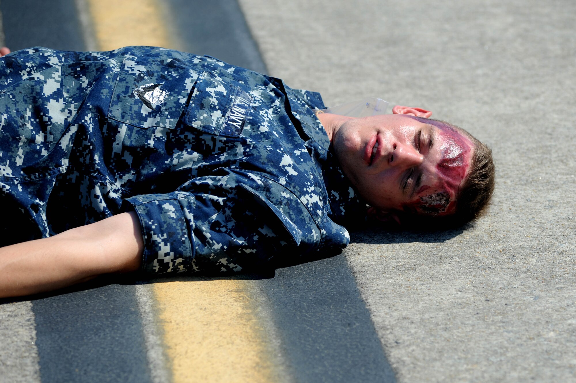 A Navy volunteer "casualty" awaits emergency response personnel during a Major Accident Response Exercise March 22, 2011 on Joint Base Charleston S.C.  The MARE is a necessary step to prepare all Joint Base Charleston members for the upcoming 2011 Air Expo .  The exercise is used to help test and train the supporting agencies who would respond in case of an emergency.  Captain Ellis-Yarian is a flight surgeon with the 628th Medical Group.  (U.S. Air Force photo/ Staff Sgt. Nicole Mickle)  (Released)