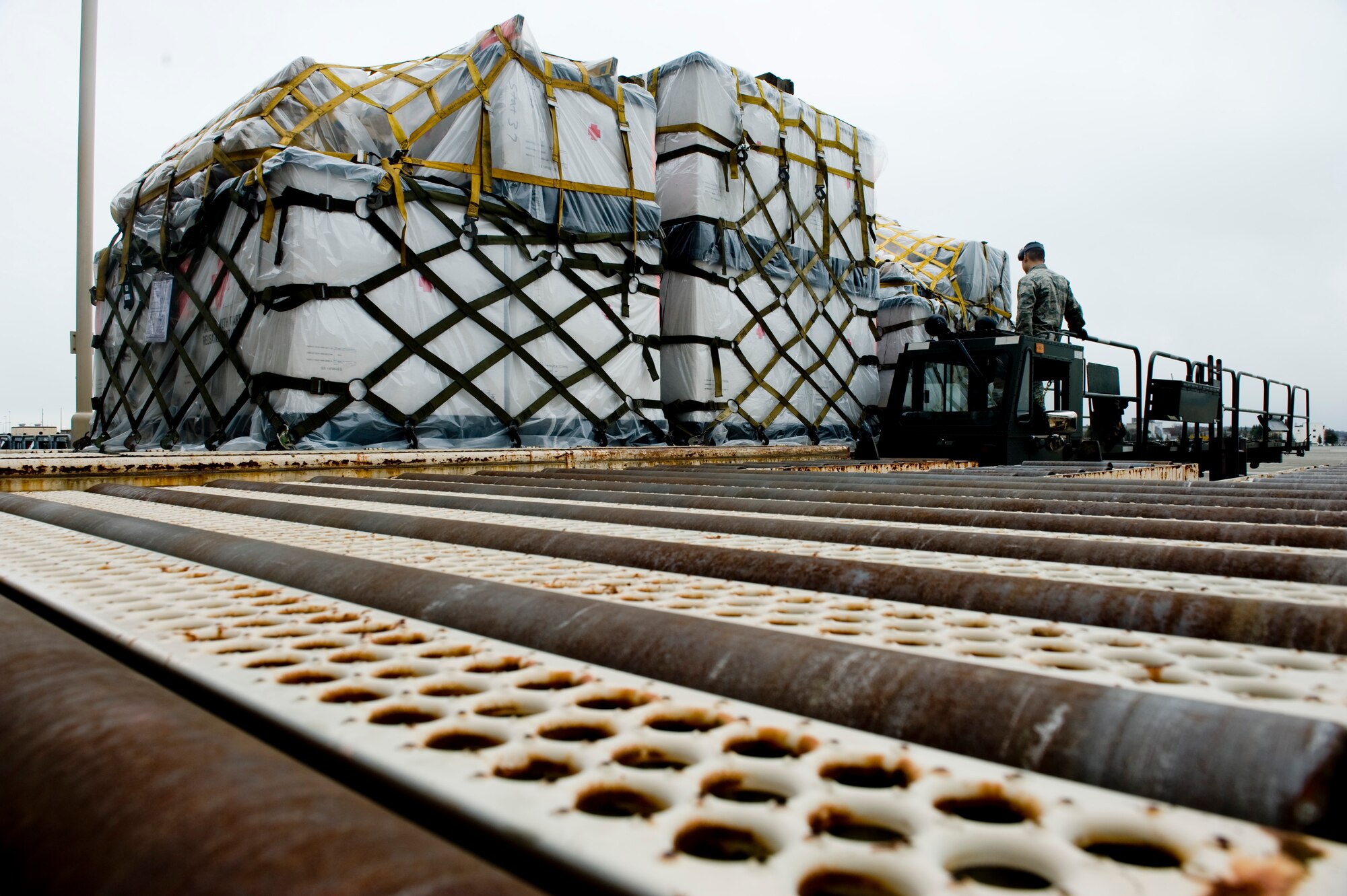 YOKOTA AIR BASE, Japan -- Airman Paul Madriles, 730th Air Mobility Squadron (AMS), watches as medical supplies for Operation Tomodachi slide into the cargo yard here March 23. The 730th AMS has been storing and delivery en-route cargo to aircraft and vehicles in support of humanitarian assistance. The cargo that the 730th AMS processed includes water, food, medical supplies and other basic needs. (U.S. Air Force photo/Staff Sgt. Jonathan Steffen)