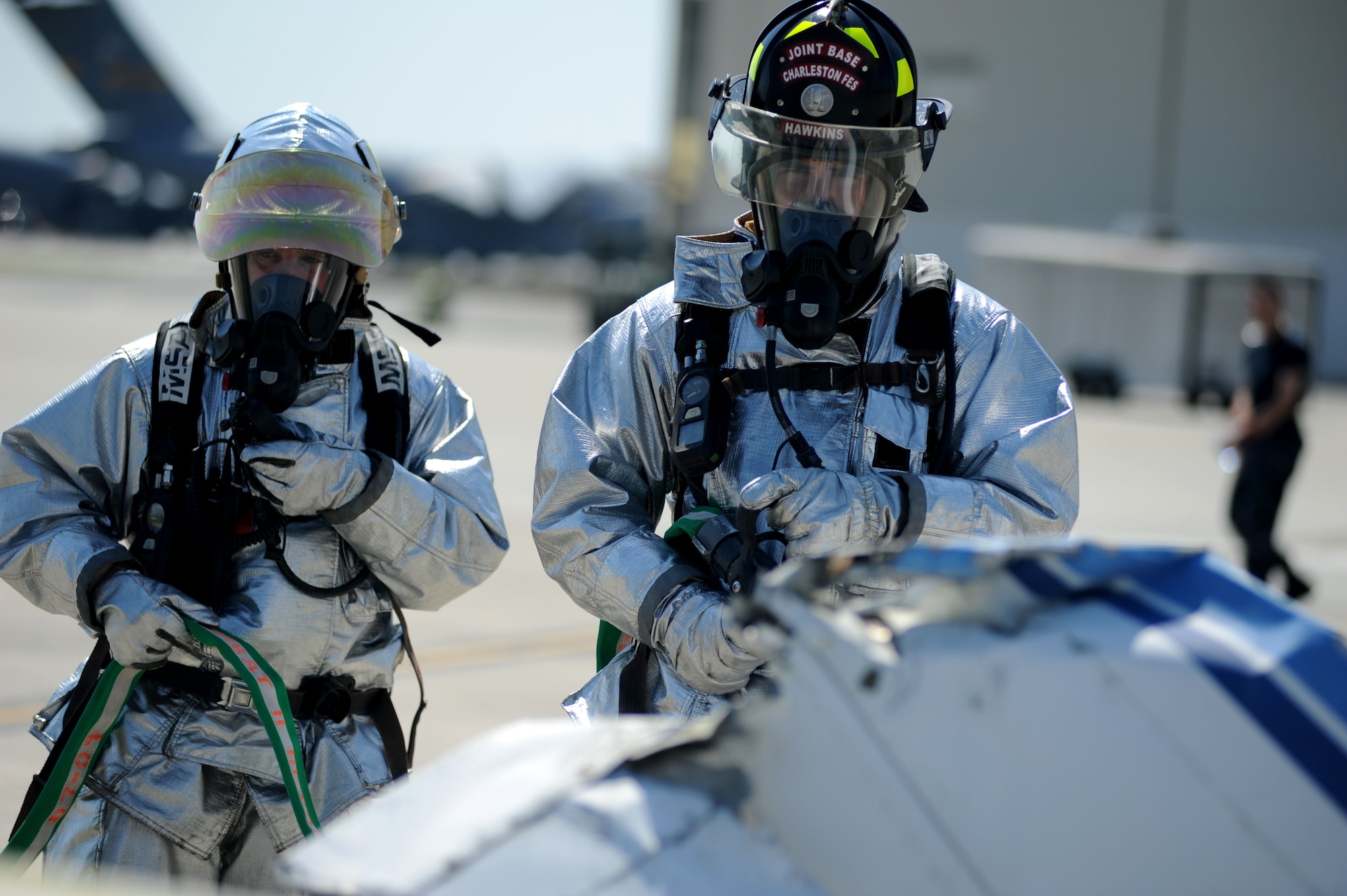 Joint Base Charleston fire fighters approach simulated crash aircraft remains during a Major Accident Response Exercise March 22, 2011 on Joint Base Charleston S.C.  The MARE is a necessary step to prepare all Joint Base Charleston members for the upcoming 2011 Air Expo .  The exercise is used to help test and train the supporting agencies who would respond in case of an emergency.  Captain Ellis-Yarian is a flight surgeon with the 628th Medical Group.  (U.S. Air Force photo/ Staff Sgt. Nicole Mickle)  (Released)