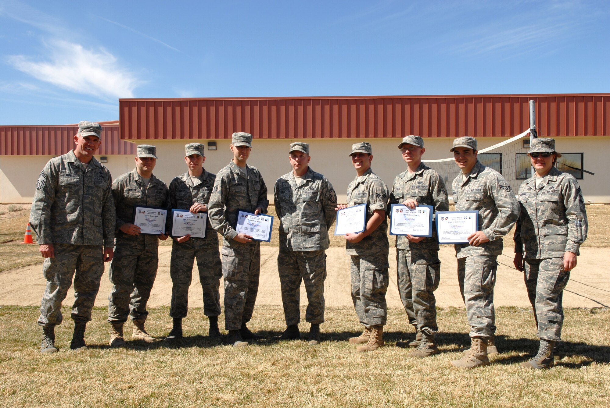 Six Edwards 95th Communication Squadron Airmen receive the Dare to Soar Award from the Chief’s Group. The six Airmen won the award March 11 for their volunteer effort to set up wireless internet at a local retirement home. In addition to setting up Wi-Fi, the Airmen also taught the residents internet safety to help them identify phishing and other internet threats. (Air Force photo by Senior Airman William A. O’Brien)
