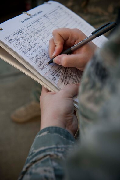 Senior Airman Jessica Roland, 23rd Operations Support Squadron airfield management shift lead, writes down information during an AF Form 483 spot check March 22 on the Moody Air Force Base, Ga., flightline. During spot checks, the driver’s government vehicle documentation is verified for being correct and current. (U.S. Air Force photo/Staff Sgt. Jamal D. Sutter)(RELEASED)