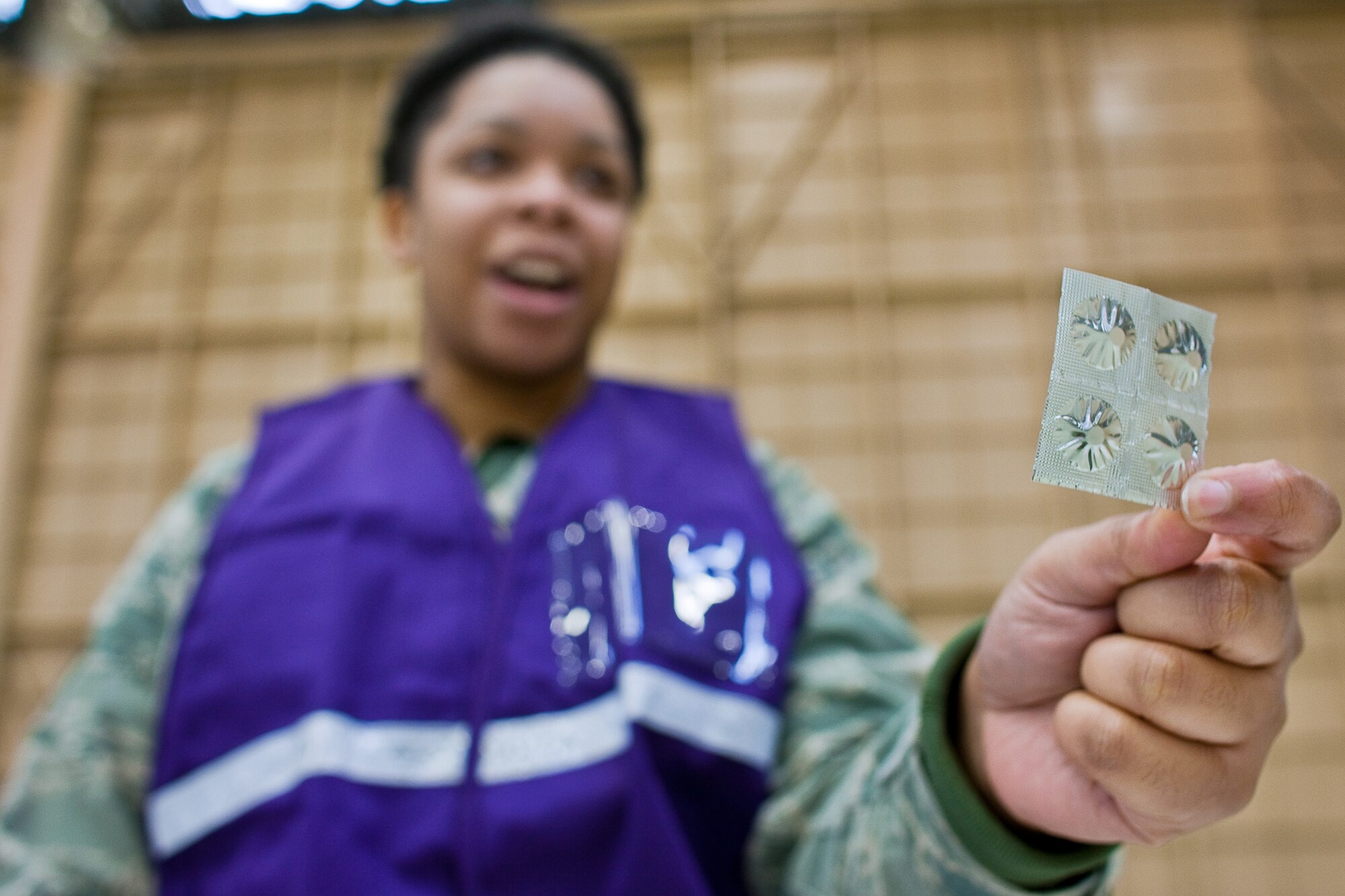 Staff Sgt. Alicia Tucker explains how and when to take potassium iodide tablets March 22, 2011, at Yokota Air Base, Japan. U.S. Pacific Command officials directed distribution of potassium iodide tablets as a precautionary measure.  Base officials are stressing there is no indication of increased exposure at Yokota AB.  Sergeant Tucker is assigned to the 374th Medical Operations Squadron. (U.S. Air Force photo/Osakabe Yasuo)