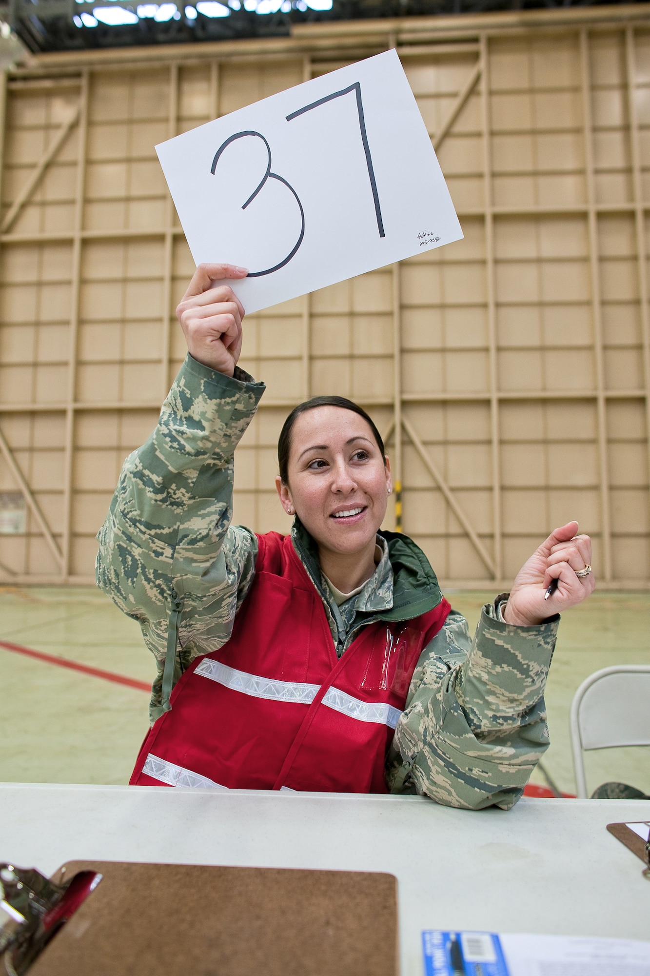 Staff Sgt. Michelle Romany calls for a customer to pick up potassium iodide tablets March 22, 2011, at Yokota Air Base, Japan. U.S. Pacific Command officials directed distribution of potassium iodide tablets as a precautionary measure.  Base officials are stressing there is no indication of increased exposure at Yokota AB. Sergeant Romany is assigned to the 374th Surgical Operations Squadron. (U.S. Air Force photo/Osakabe Yasuo)
