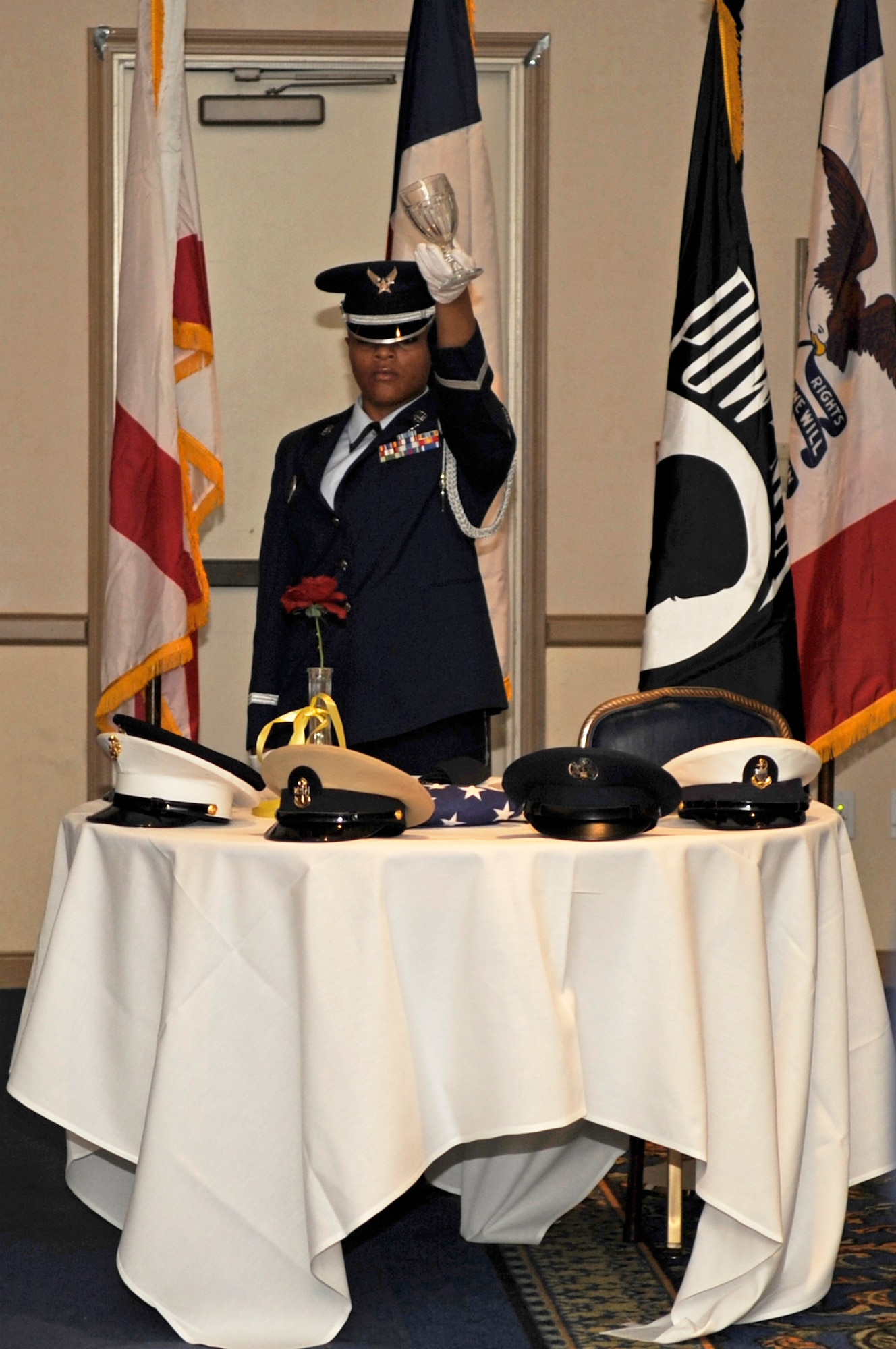 VANDENBERG AIR FORCE BASE, Calif. – A member of the Vandenberg Honor Guard tips an empty water glass during a Prisoner of War and Missing in Action ceremony at the 14th Air Force and Joint Functional Component Command for Space’s Annual Awards Banquet at the Pacific Coast Club here Friday, March 18, 2011.The MIA/POW ceremony commemorates troops captured and (or) were missing in action. The flag stands as a powerful symbol of America’s national commitment to the POW/MIAs. (U.S. Air Force photo/Senior Airman Lael Huss)