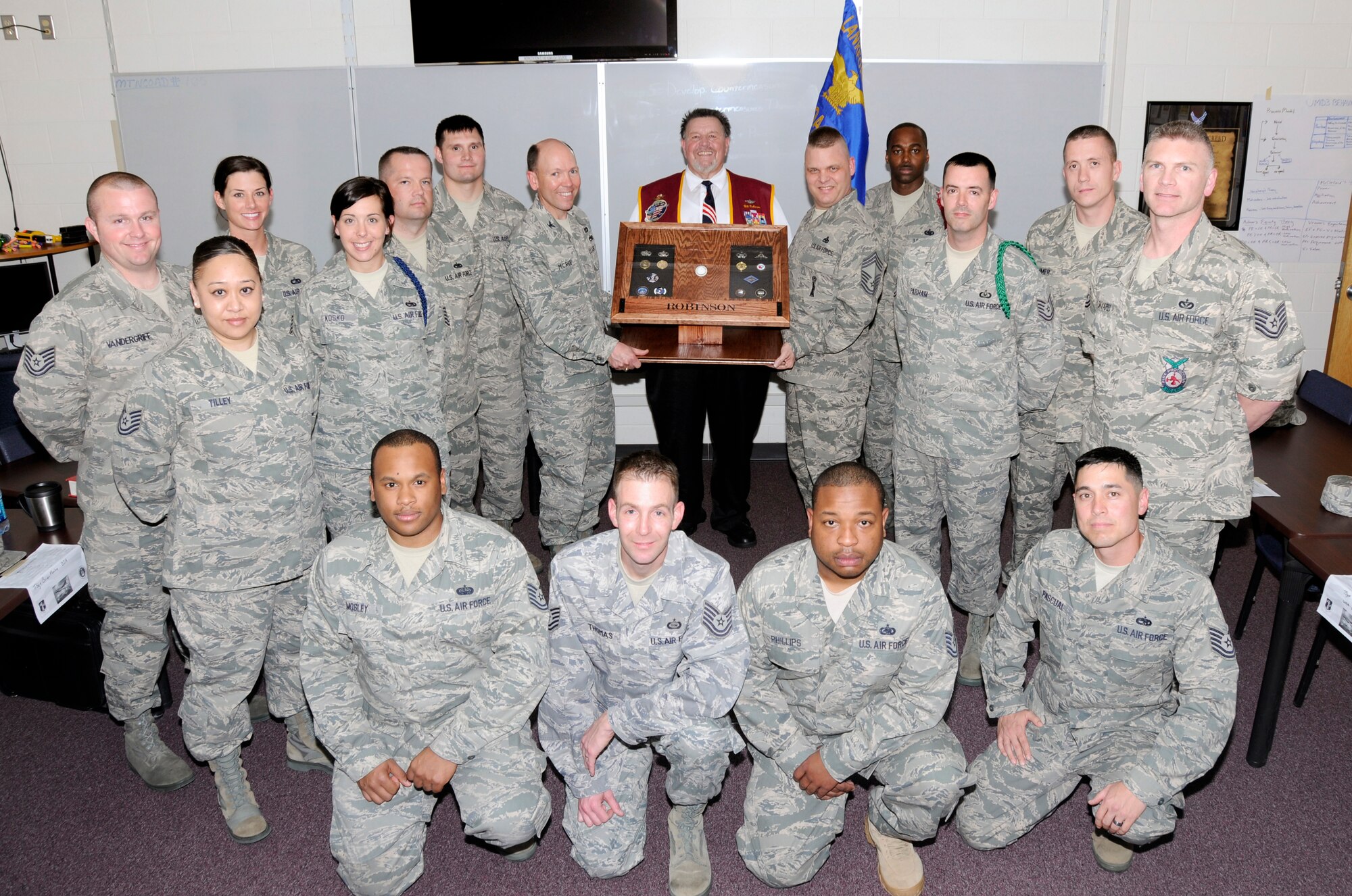 McGHEE TYSON AIR NATIONAL GUARD BASE, Tenn. - Members of NCO Academy Class 11-3, D-flight honor retired Air Force Capt. William A. Robinson, center, the first enlisted POW of the Vietnam War by dedicating their flight room in Morrisey Hall as the Robinson Room in his honor, March 22, 2011.  The center dedicated the room in a tribute to enlisted heroes. (U.S. Air Force photo by Master Sgt. Kurt Skoglund/Released)