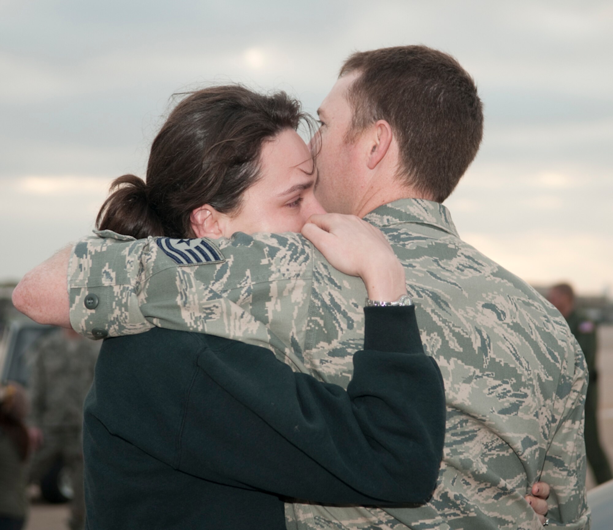 Tech. Sgt. James Stiles consoles his wife as they say their final good byes prior to boarding the C-130H aircraft from NAS Fort Worth JRB, March 18, 2011. Colleagues, family members and friends gathered for last minute words of support and encouragement as their loved ones boarded the aircraft for the long trip to the desert. (U.S. Air Force Photo by Senior Master Sgt. Elizabeth Gilbert/released)