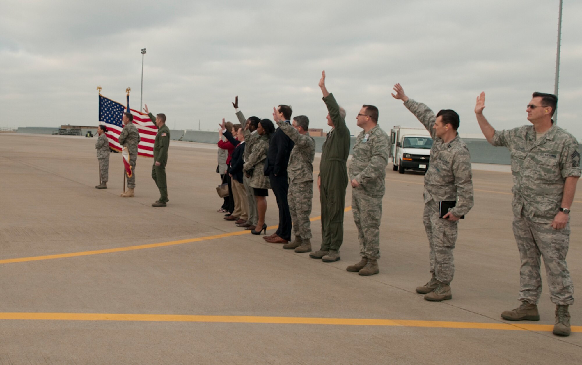 Members of the 136th Airlift Wing and elected official representatives wave good bye to deploying members aboard the wing's C-130H aircraft headed for Afghanistan from NAS Fort Worth JRB, Texas, March 18, 2011. The 136th Airlift Wing, in support of Operation ENDURING FREEDOM, has deployed over 1,000 Airmen over the course of 23 Air Expeditionary Force deployments, since 2003. (U.S. Air Force photo by Senior Master Sgt. Elizabeth Gilbert/released)