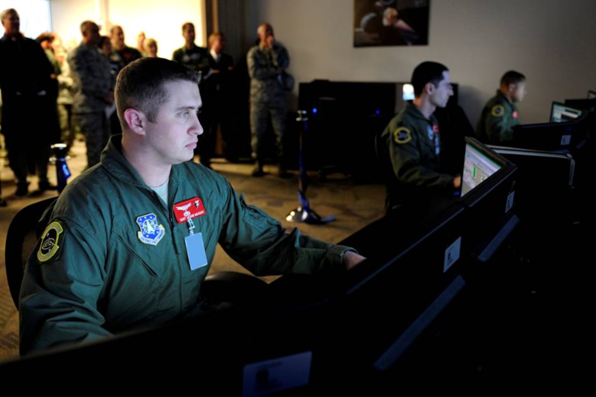Staff Sgt. Jason Wassom, 3rd Space Operations Squadron, sits at a student station in the new Standard Space Trainer (SST) Integrated Training Center at Schriever Air Force Base in Colorado following the ribbon cutting and official opening of the new system. The technology concept for the SST was developed by scientists and engineers at the Air Force Research Laboratory, 711th Human Performance Wing, Human Effectiveness Directorate, Warfighter Readiness Research Division, Continuous Learning and Performance Assessment Branch (711 HPW/RHAS). (U.S. Air Force photo/Dennis Rogers)