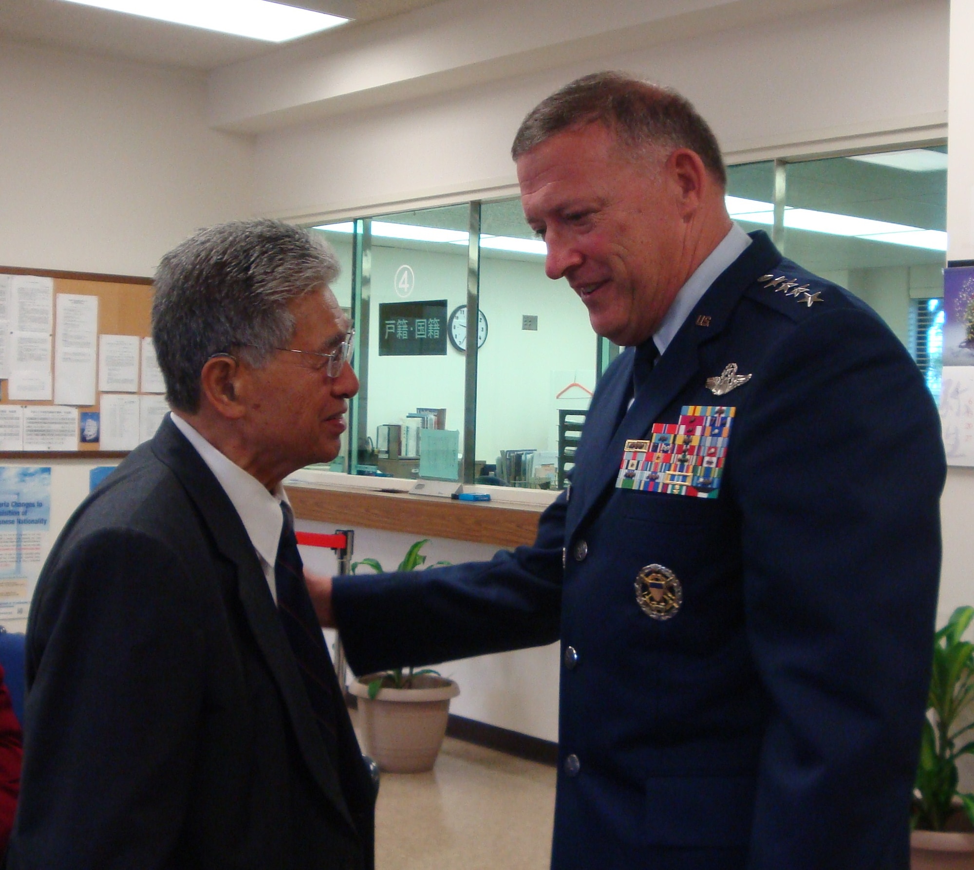 Gen. Gary North, Pacific Air Forces commander, talks with Hawaii Sen. Daniel K. Akaka March 22, 2011, at the Consulate General of Japan in Honolulu. Both expressed their sympathies in a condolence book following the deadly destruction caused by the earthquake and destructive tsunami that hit Japan on March 11. (U.S. Air Force photo/Lt. Col. Tracey Saiki)