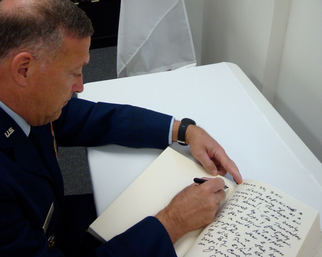 Gen. Gary North, Pacific Air Forces commander, conveys his sympathy for the Japanese people in a condolence book March 22, 2011, at the Consulate General of Japan in Honolulu. The condolence book, signed by federal, state, city and county government agency officials and U.S. military leaders, held expressions of sympathy for the deadly destruction after the earthquake and destructive tsunami hit Japan March 11. (U.S. Air Force photo/Lt. Col. Tracey Saiki)