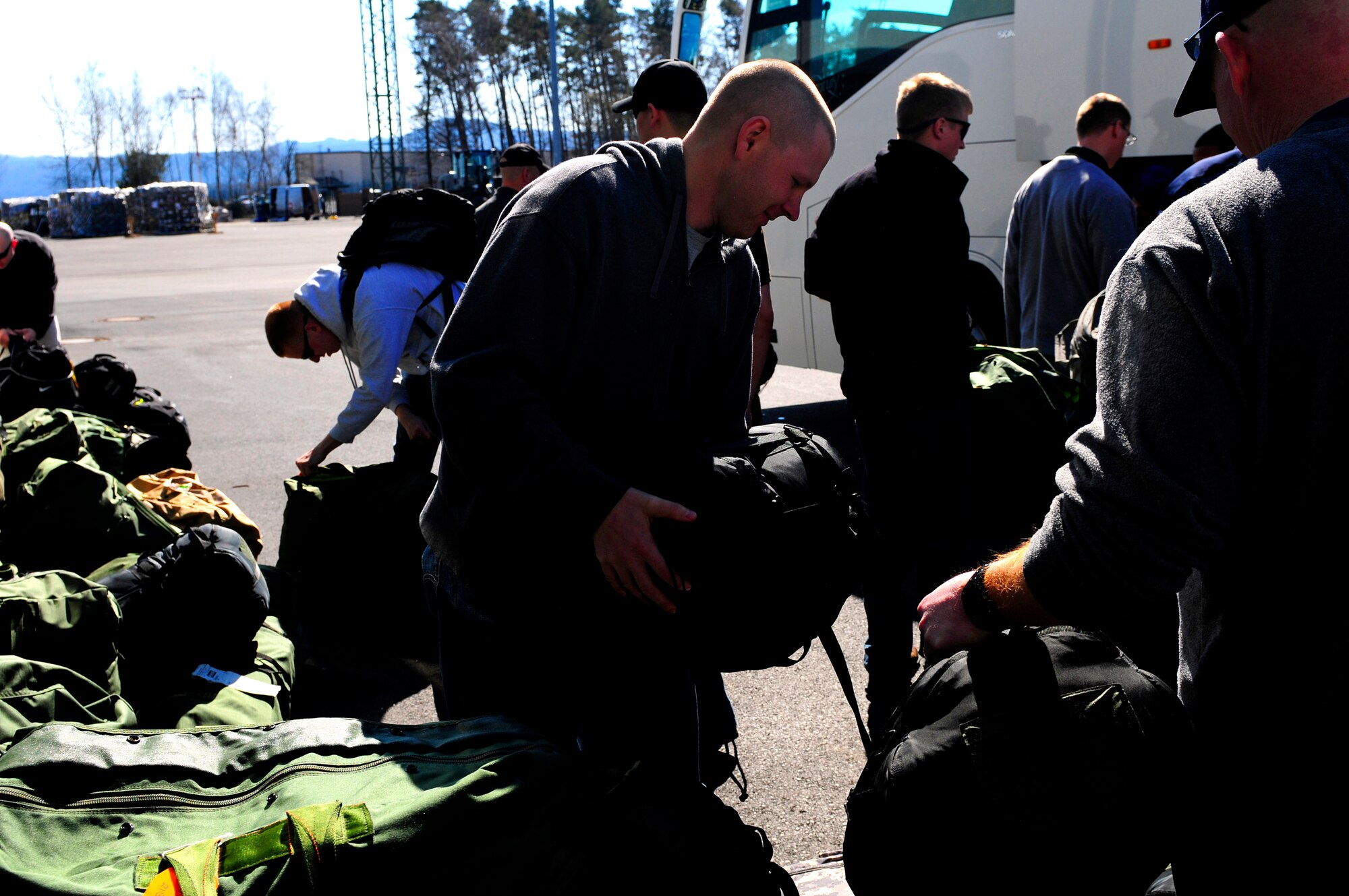 U.S. Air Force Airmen from the 86th Civil Engineer Squadron load cargo on a bus in preparation for a deployment in support of Joint Task Force Odyssey Dawn, Ramstein Air Base, Germany, March 21, 2011. The U.S. Africa Command task force was established to provide operational and tactical command and control of U.S. military forces supporting the international response to the unrest in Libya and enforcement of United Nations Security council Resolution 1973. UNSCR 1873 authorizes all necessary measures to protect civilians in Libya under threat of attack by Qadhafi regime forces. JTF Odyssey Dawn is commanded by U.S. Navy Admiral Samuel J. Locklear, III.   (U.S. Air Force Photo by Airman 1st Class Brea Miller)
