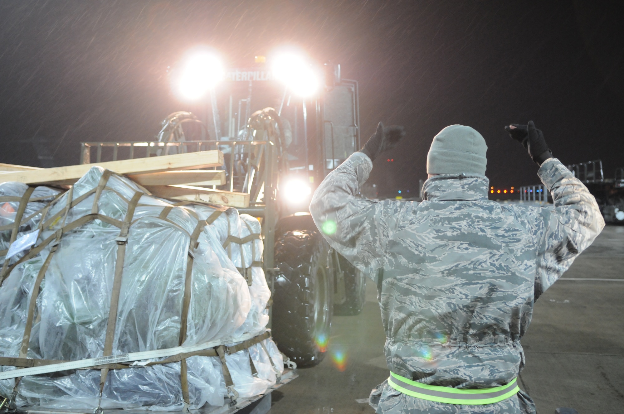 SPANGDAHLEM AIR BASE, Germany –An Airman assigned to the 52nd Logistics Readiness Squadron guides his fellow Airman while moving pallets onto a scale to be weighed here in preparation for shipment in support Operation Odyssey Dawn March 19. Joint Task Force Odyssey Dawn is the U.S. Africa Command task force established to provide operational and tactical command and control of U.S. military forces supporting the international response to the unrest in Libya and enforcement of United Nations Security Council Resolution (UNSCR) 1973. UNSCR 1973 authorizes all necessary measures to protect civilians in Libya under threat of attack by Qadhafi regime forces.  JTF Odyssey Dawn is commanded by U.S. Navy Admiral Samuel J. Locklear, III. (U.S. Air Force photo/Airman 1st Class Matthew B. Fredericks)