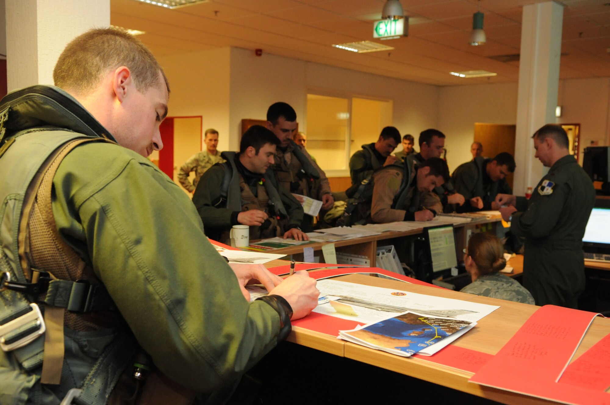 SPANGDAHLEM AIR BASE, Germany – Pilots from the 480th Fighter Squadron receive a briefing at the squadron here before leaving to support of Operation Odyssey Dawn March 19. Joint Task Force Odyssey Dawn is the U.S. Africa Command task force established to provide operational and tactical command and control of U.S. military forces supporting the international response to the unrest in Libya and enforcement of United Nations Security Council Resolution (UNSCR) 1973. UNSCR 1973 authorizes all necessary measures to protect civilians in Libya under threat of attack by Qadhafi regime forces.  JTF Odyssey Dawn is commanded by U.S. Navy Admiral Samuel J. Locklear, III. (U.S. Air Force photo/Staff Sgt. Benjamin Wilson)