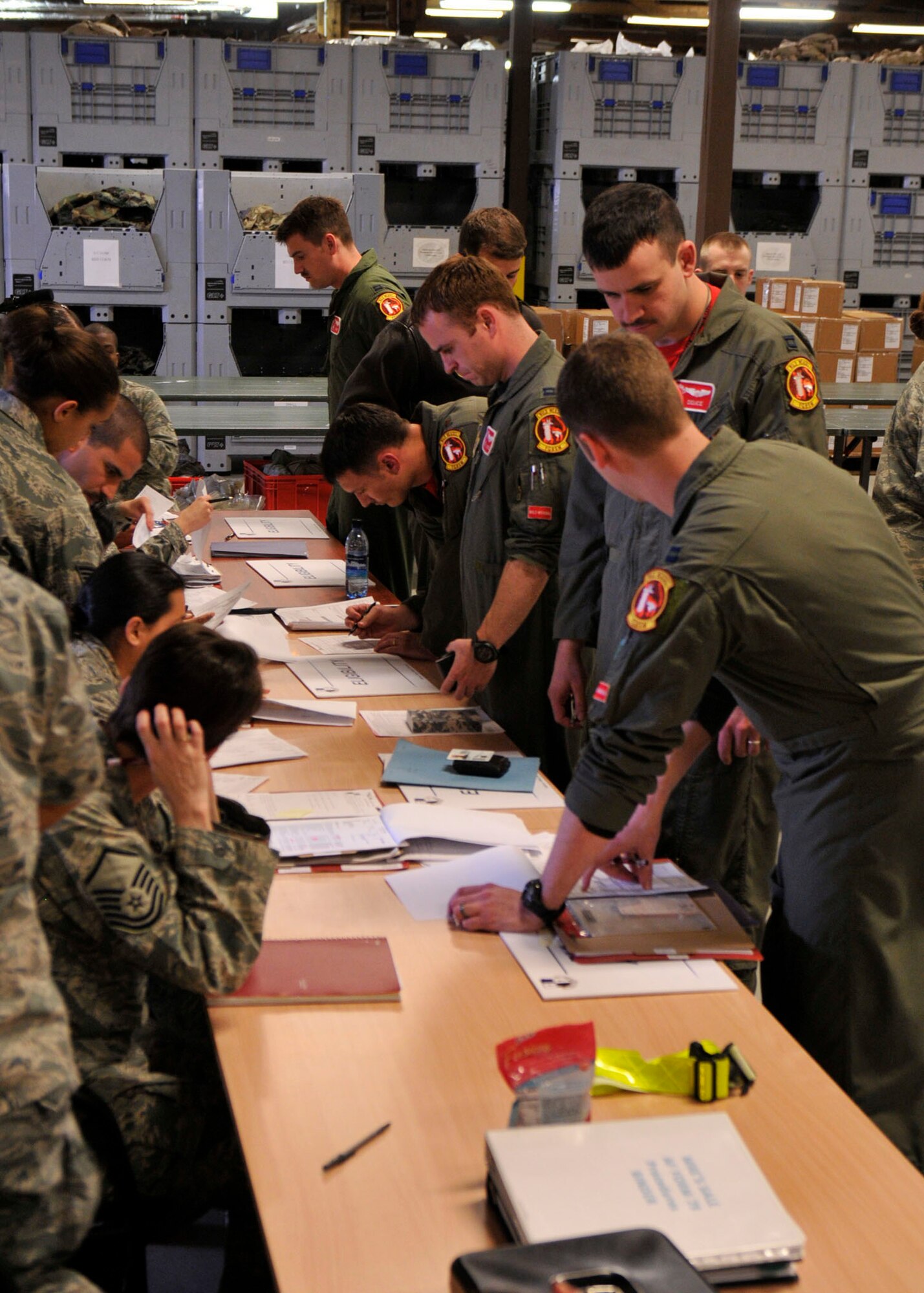 SPANGDAHLEM AIR BASE, Germany— Pilots from the 480th Fighter Squadron process through the Personnel Deployment Function line in preparation of Operation Odyssey Dawn March 18. Joint Task Force Odyssey Dawn is the U.S. Africa Command task force established to provide operational and tactical command and control of U.S. military forces supporting the international response to the unrest in Libya and enforcement of United Nations Security Council Resolution (UNSCR) 1973. UNSCR 1973 authorizes all necessary measures to protect civilians in Libya under threat of attack by Qadhafi regime forces.  JTF Odyssey Dawn is commanded by U.S. Navy Admiral Samuel J. Locklear, III. (U.S. Air Force photo/Airman 1st Class Brittney Frees)