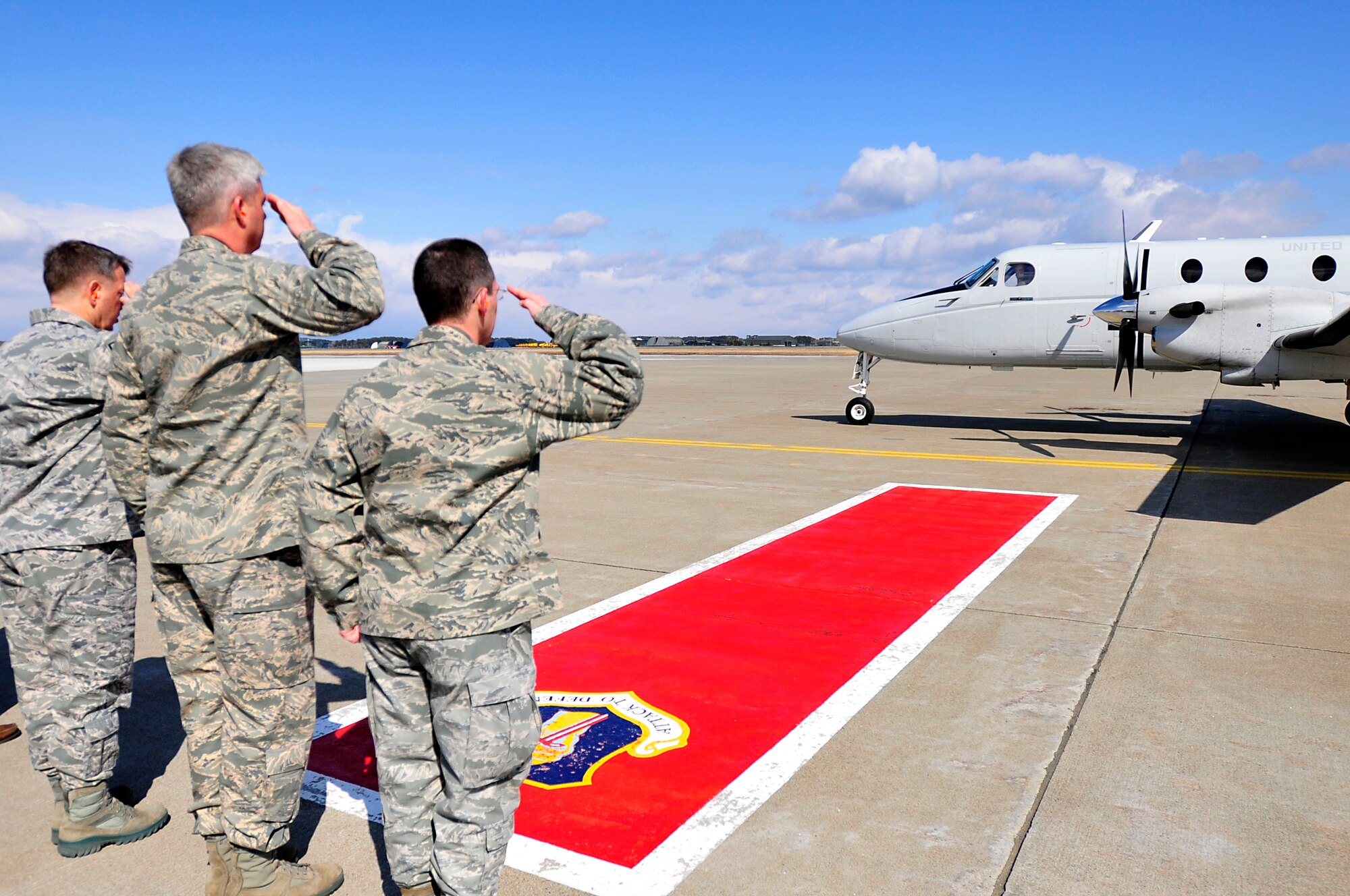 MISAWA AIR BASE, Japan -- Col. Michael Rothstein, 35th Fighter Wing commander, right, and Col. Al Wimmer, 35 FW vice commander,center, along with Chief Master Sgt. Russell Hastings, 35 FW command chief, salutes as Brig. Gen. John Raymond, 5th Air Force vice commander, taxis to the parking spot Mar. 23. General Raymond and Chief Master Sgt. Andy Kaiser, U.S. Forces Japan and 5th Air Force command chief, paid a brief visit to check up on the morale and welfare of the Airmen and Sailors here. (U.S. Air Force photo by Staff Sgt. Marie Brown\Released)
