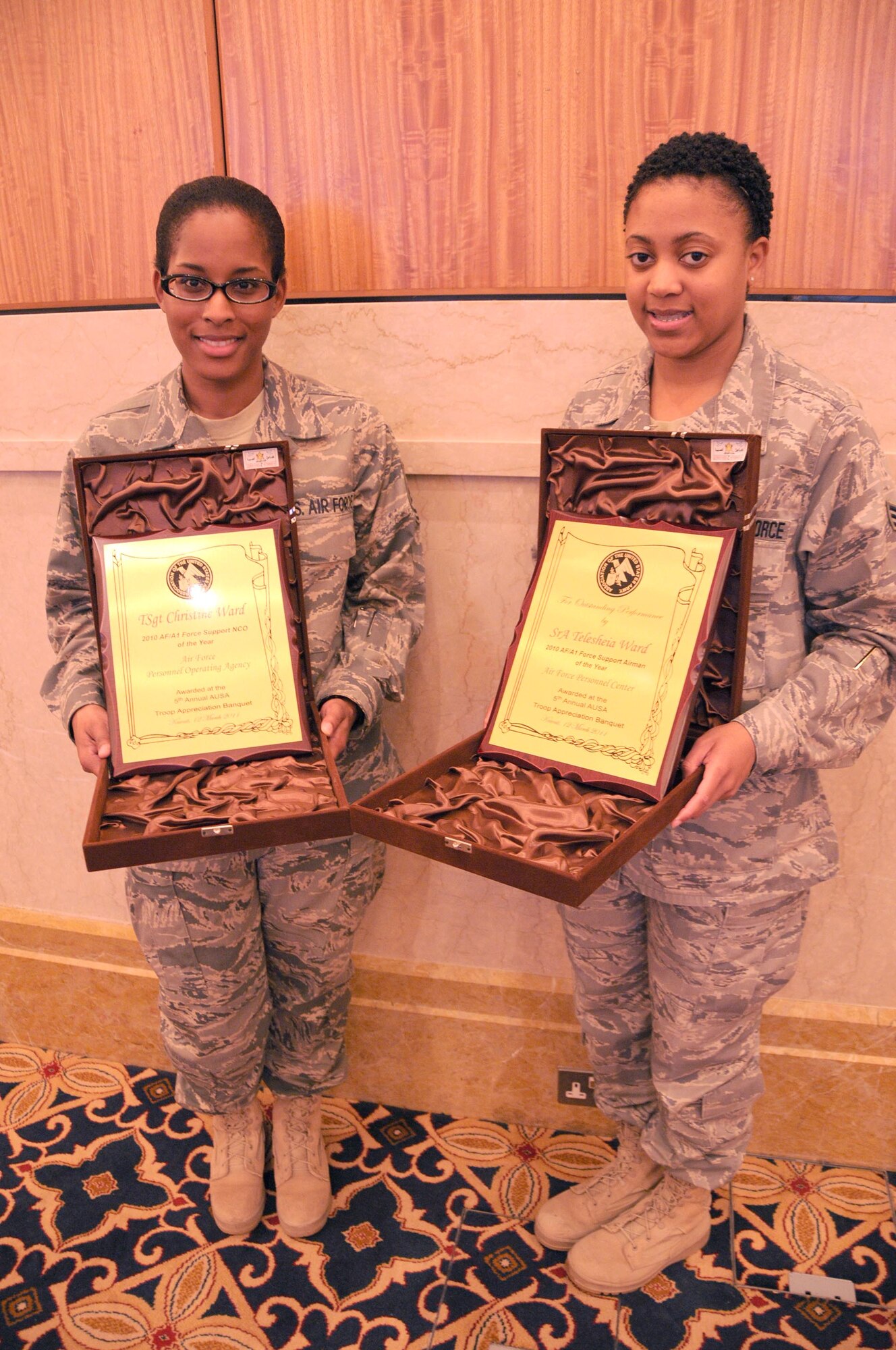 Tech. Sgt. Christine Ward (left) and Senior Airman Telesheia Ward were recognized along with other Soldiers, Sailors, Marines and Coast Guardsmen at the 4th Annual Association of the United States Army Servicemember Appreciation banquet in Southwest Asia March 12. Sergeant Ward, the non-commissioned officer in charge of casualty operations at the Casualty Assistance Center, and Airman Ward, a casualty operations technician at the Casualty Assistance Center, are both assigned to the 387th Expeditionary Support Squadron here and deployed from Randolph Air Force Base, Texas. (U.S. Air Force photo by Staff Sgt. Patrice Clarke)
