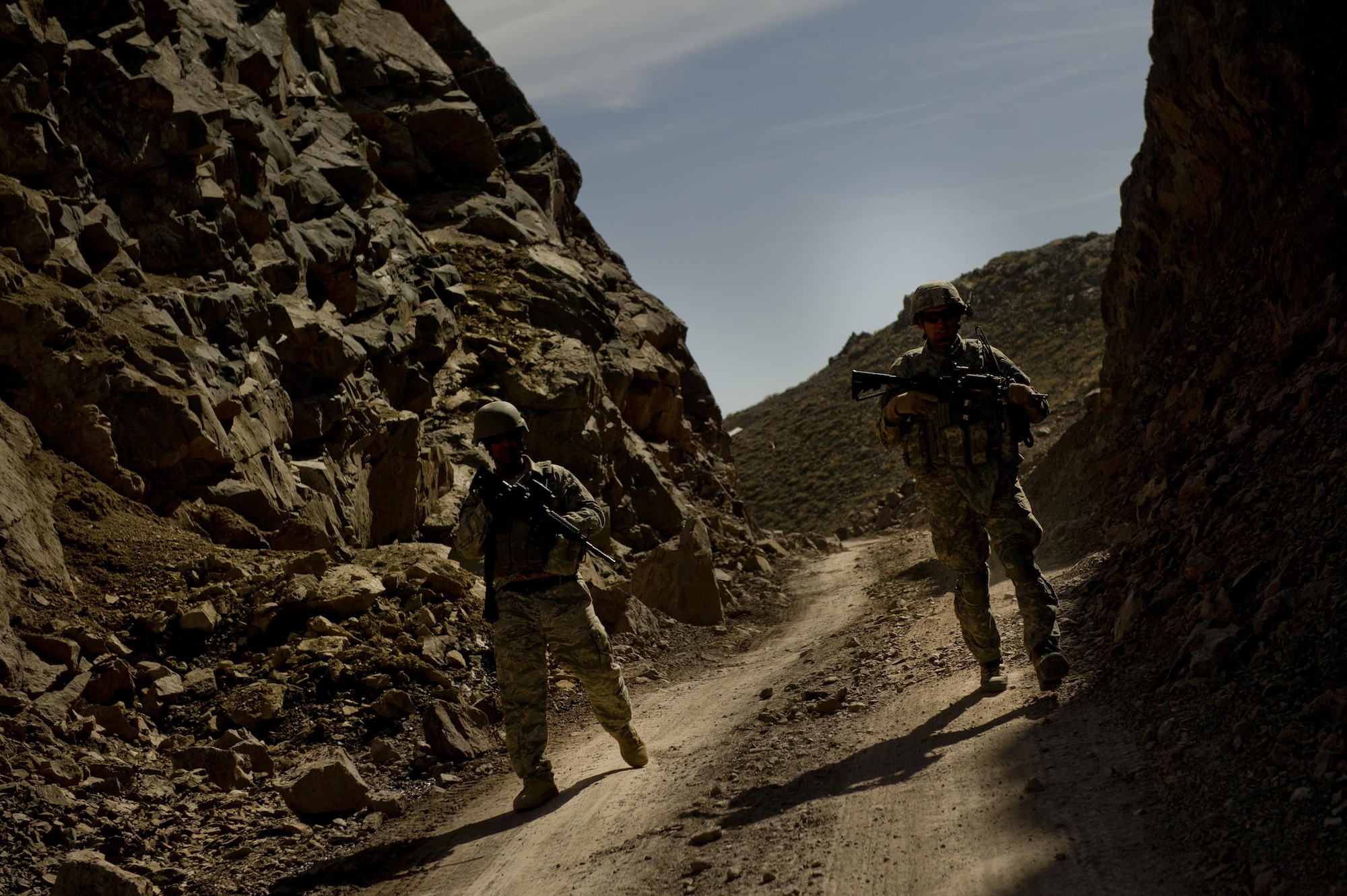 Air Force Lt. Col. Andy Veres, Provincial Reconstruction Team Zabul Commander, and Staff Sgt. Nyx Nieves Lopez, 1st Combat Camera Squadron help provide security in the Daub Pass of the mountains in Zabul province in Afghanistan during a short halt. The PRT was returning from a supply delivery mission to Forward Operating Base Sweeney. The PRT consists of members from the Air Force, Army, and civilian agencies.
