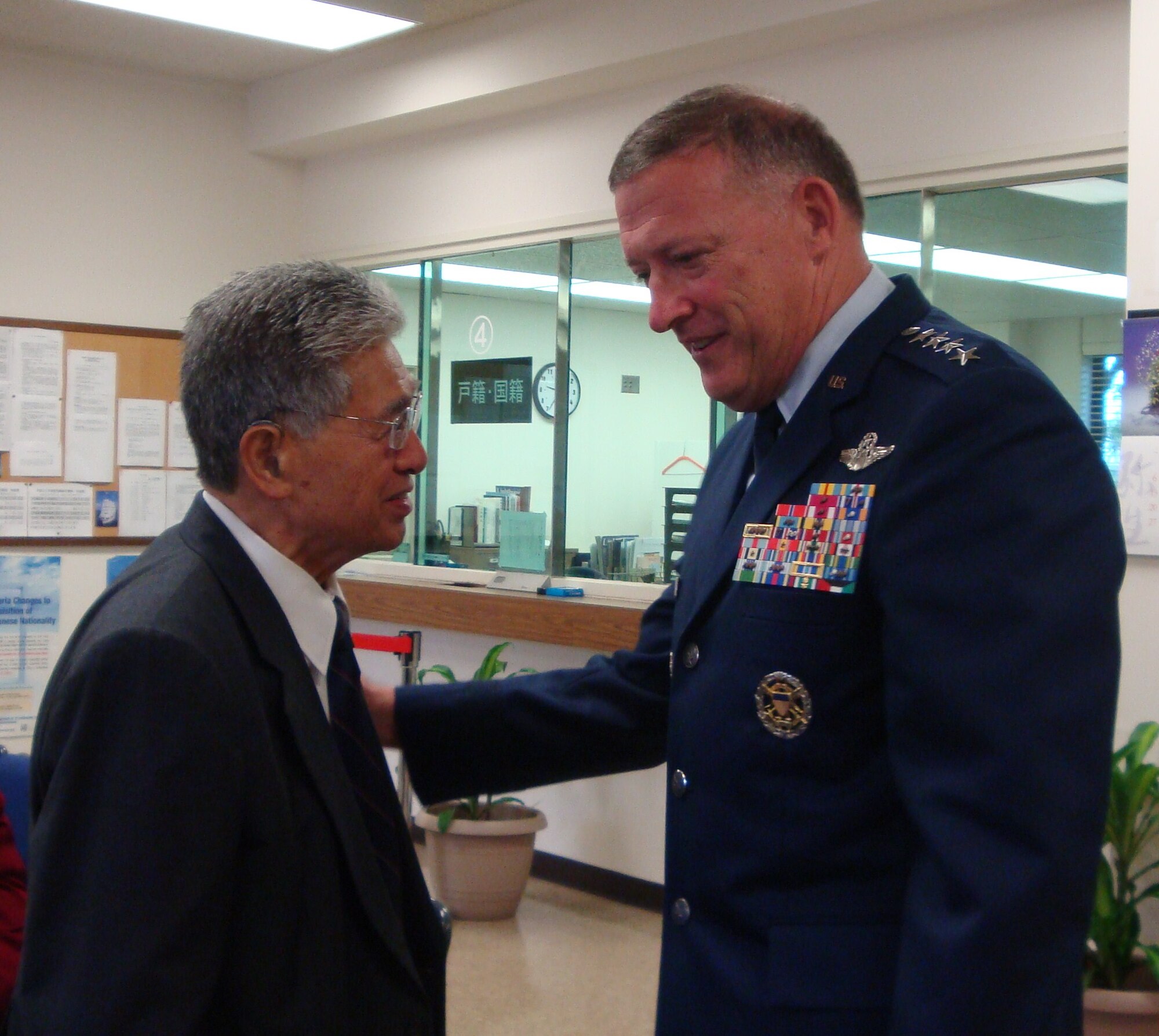 Gen. Gary L. North, Pacific Air Forces commander, talks with Sen. Daniel K. Akaka of Hawaii March 22, 2011, at the Consulate General of Japan in Honolulu, Hawaii. Both expressed their sympathies in a condolence book following the deadly destruction caused by a 9.0 magnitude earthquake and destructive tsunami that hit Japan on March 11, 2011. (U.S. Air Force photo/Lt. Col. Tracey Saiki)  