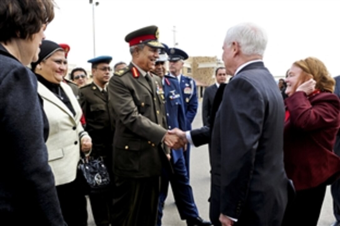 Egyptian Maj. Gen. Hassan el Rouni greets U.S. Defense Secretary Robert M. Gates and his wife, Becky, right, upon their arrival in Cairo, March 23, 2011.