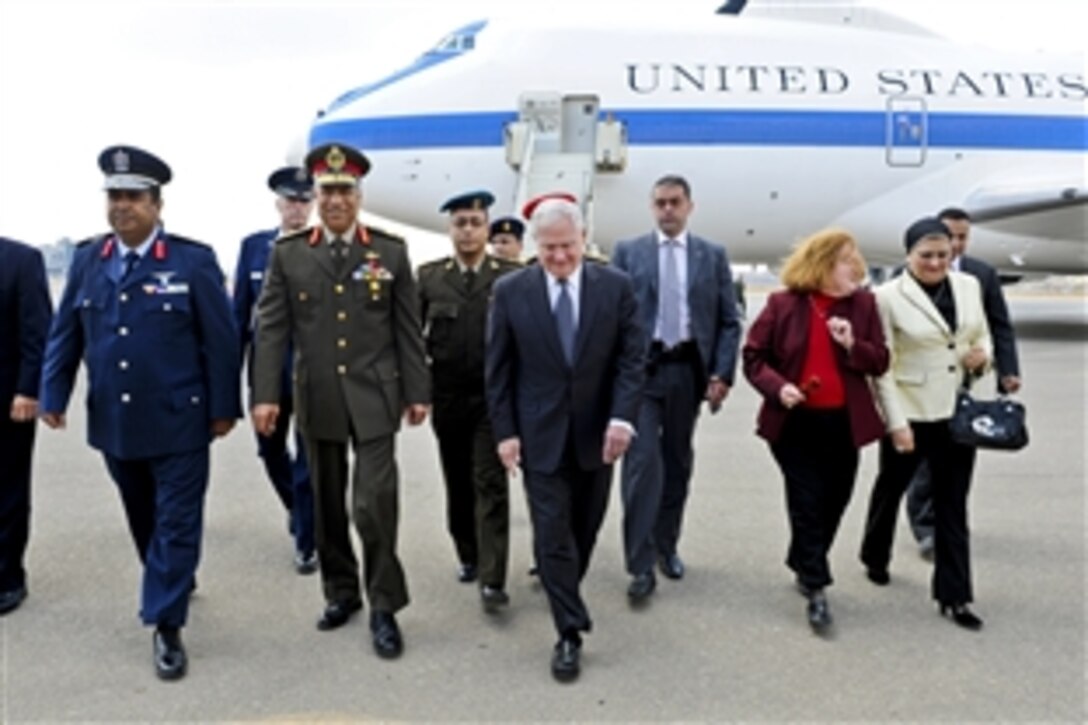 U.S. Defense Secretary Robert M. Gates and his wife, Becky, second from right, walk with Egyptian Maj. Gen. Hassan el Rouni, second from left, upon their arrival in Cairo, March 23, 2011.