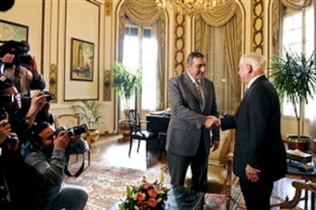 U.S. Defense Secretary Robert M. Gates, right, shakes hands in front of the press with Egyptian Prime Minister Essam Sharaf in Cairo, March 23, 2011. 