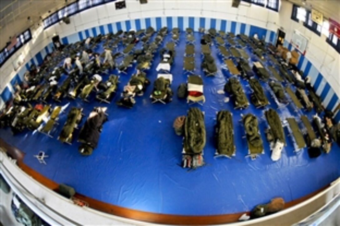 Service members deployed to Aviano Air Base, Italy to support Joint Task Force Odyssey Dawn temporarily reside in the base's Falcon Fitness Center, March 22, 2011. The task force is the U.S. Africa Command task force established to support the larger international response to the unrest in Libya.