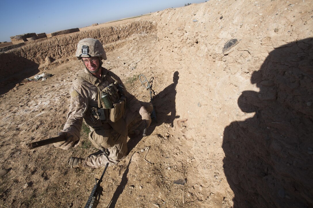 Lance Cpl. Parker Hobbs, a combat engineer with Fox Company, 2nd Battalion, 3rd Marine Regiment, unearths an AK-47 magazine in Southern Marjah, March 23, during Operation Watchtower. Fox Company found approximately 10 weapons caches during Watchtower. The operation, devised by Regimental Combat Team 1, targeted suspected insurgent bed-down and supply locations in Central Helmand province, Afghanistan. Watchtower, which included four battalions from RCT-1, ran in conjunction with Marine patrols near the Pakistan border to preempt a possible influx of insurgent fighters this spring.