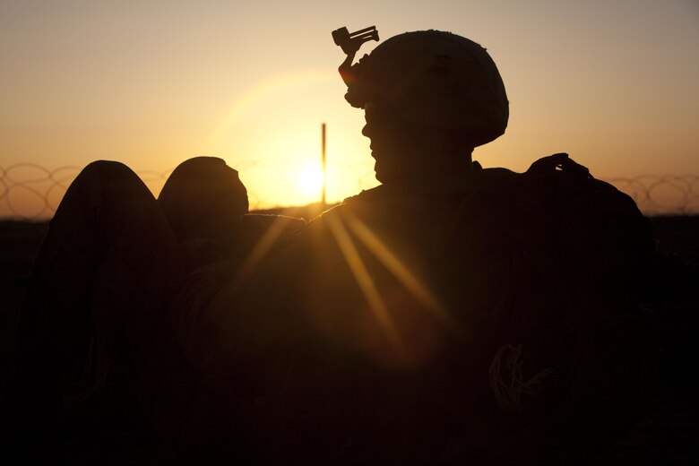 Lance Cpl. Joseph Marshall, a squad automatic weapon gunner with Fox Company, 2nd Battalion, 3rd Marine Regiment, waits for the sun to rise in Southern Marjah District, Helmand province, Afghanistan, March 23, the first day of Operation Watchtower. Marshall is from Glenallen, Alaska.