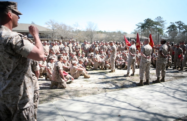 Marines with Combat Logistics Battalion 2, 2nd Marine Logistics Group, sit in a school circle as Lt. Col. Brian Wolford, the commanding officer for CLB-2, speaks with them during a ceremony aboard Camp Lejeune, N.C., March 24, 2011.  During the ceremony 13 Marines were recognized for actions while deployed to Afghanistan from July 2010 to February 2011.