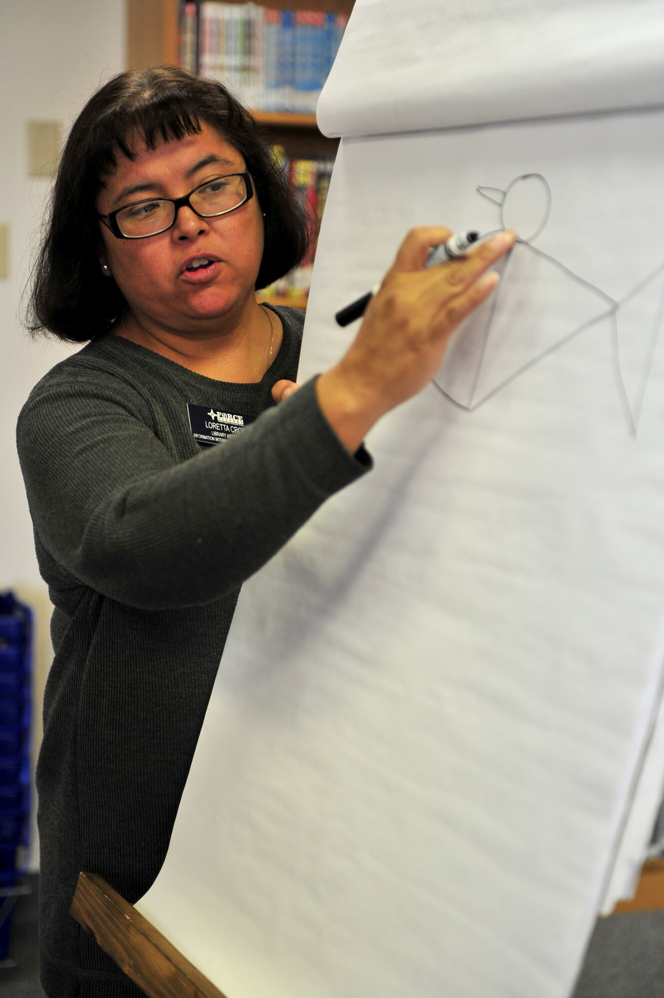Loretta Croke, a library staff member instructs children on drawing using basic shapes during Petite Picasso, at the Cannon Air Force Base, N.M. library, March 24, 2011. Petite Picasso, run by the Cannon AFB library, provides art instruction to young children free of charge, for more information call 575-784-2786. (U.S. Air Force photo by Tech Sgt. Josef Cole)(RELEASED) 

