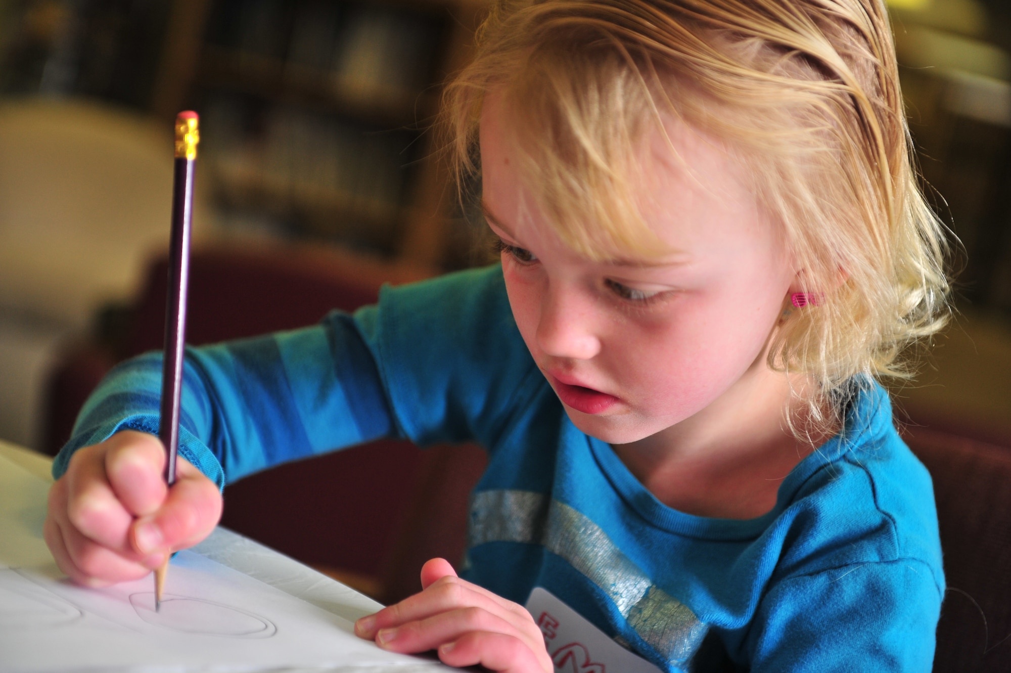 Emma Guinan, daughter of U.S. Air Force Lt. Col. Daniel Guinan, 27th Special Operations Civil Engineer Squadron commander, and Karen Guinan; puts pencil to paper during Petite Picasso, at the Cannon Air Force Base, N.M. library, March 24, 2011. Petite Picasso, run by the Cannon AFB library, provides art instruction to young children free of charge, for more information call 575-784-2786. (U.S. Air Force photo by Tech Sgt. Josef Cole)(RELEASED) 

