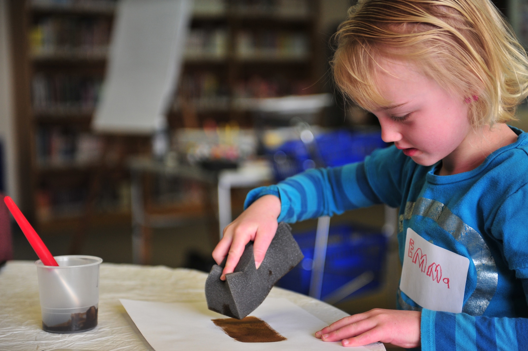 Emma Guinan, daughter of U.S. Air Force Lt. Col. Daniel Guinan, 27th Special Operations Civil Engineer Squadron commander, and Karen Guinan; puts sponge to paper during Petite Picasso, at the Cannon Air Force Base, N.M. library, March 24, 2011. Petite Picasso, run by the Cannon AFB library, provides art instruction to young children free of charge, for more information call 575-784-2786. (U.S. Air Force photo by Tech Sgt. Josef Cole)(RELEASED) 

