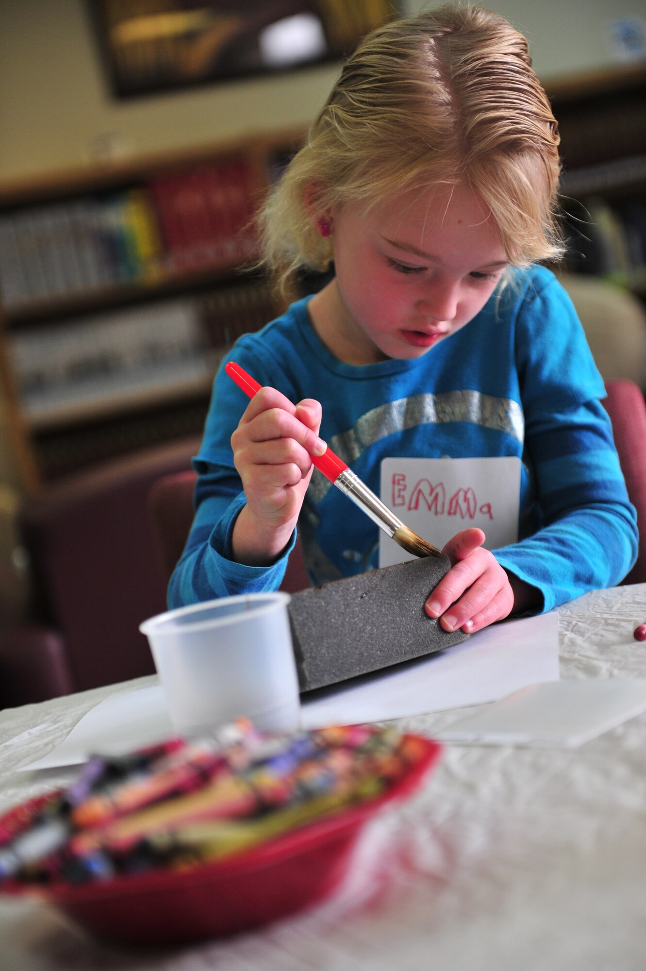 Emma Guinan, daughter of U.S. Air Force Lt. Col. Daniel Guinan, 27th Special Operations Civil Engineer Squadron commander, and Karen Guinan; puts brush to sponge during Petite Picasso, at the Cannon Air Force Base, N.M. library, March 24, 2011. Petite Picasso, run by the Cannon AFB library, provides art instruction to young children free of charge, for more information call 575-784-2786. (U.S. Air Force photo by Tech Sgt. Josef Cole)(RELEASED) 

