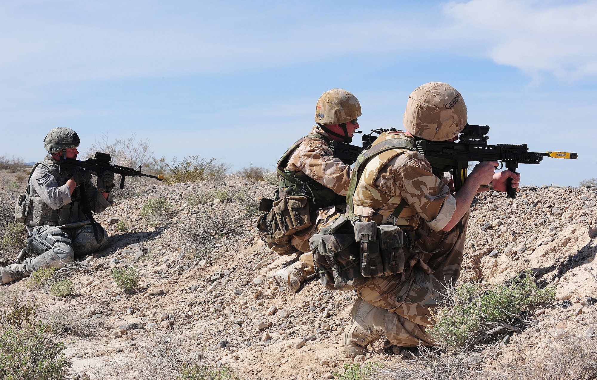 Tech. Sgt. Sean Gray and British airmen provide protection for a four-man foot patrol March 14, 2011, during Desert Eagle at the Nevada Test and Training Range. Sergeant Gray is an 822nd Base Defense Squadron squad leader. (U.S. Air Force photo/Senior Airman Stephanie Mancha)
