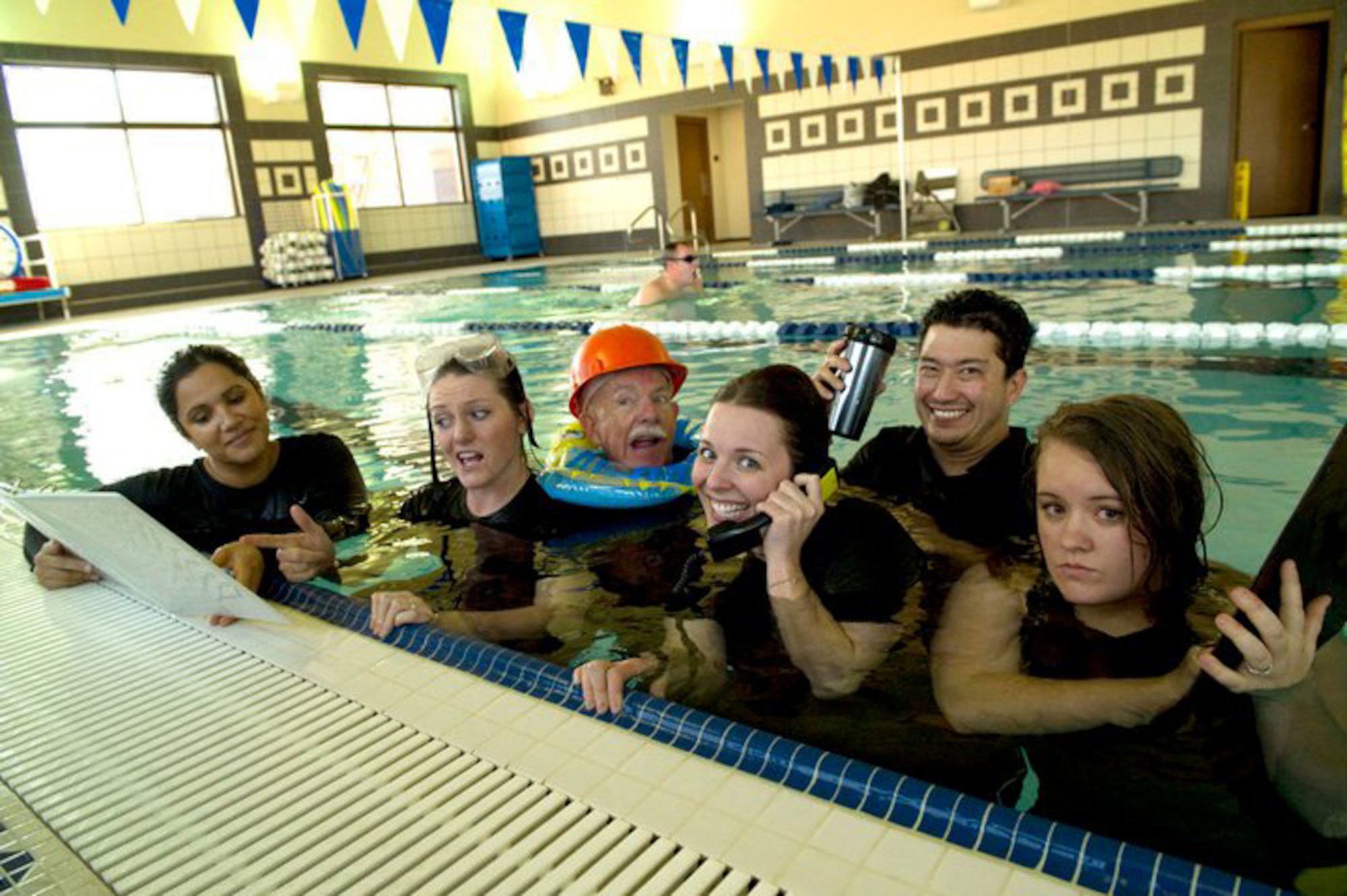 HOLLOMAN AIR FORCE BASE, N.M. -- The 49th Force Support Squadron Marketing Office demonstrates their “ALL IN” attitude at the Domenici Fitness and Sports Center indoor pool recently. The Holloman Marketing team was recently named best in Air Combat Command for 2010. Their mission is to ensure programs and events on base are successful and that people know about them. They’ve done this by reaching out to the base through multiple events last year including the Big Give and Hollognome Projects. (Courtesy photo) 