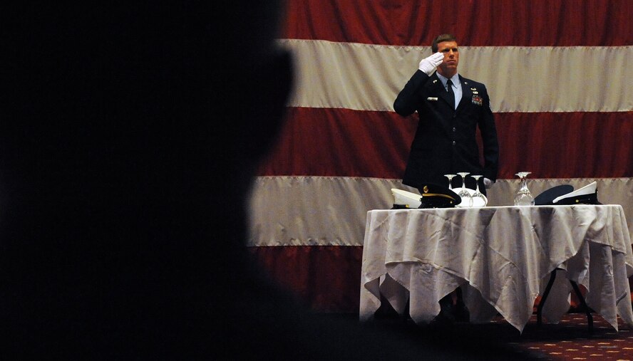 Staff Sgt. Sean Mitchell, 20th Air Support Operations Squadron, renders a salute during the Fallen Comrade's Tribute during Barksdale's Airman Leadership School graduation at Hoban Hall March 24. ALS is the first step in professional military education for all Airmen — Class 11-4 had 62 graduates who will return to their work centers and utilize the skills they learned in their first PME experience. (U.S. Air Force photo/Senior Airman La'Shanette V. Garrett) (RELEASED)