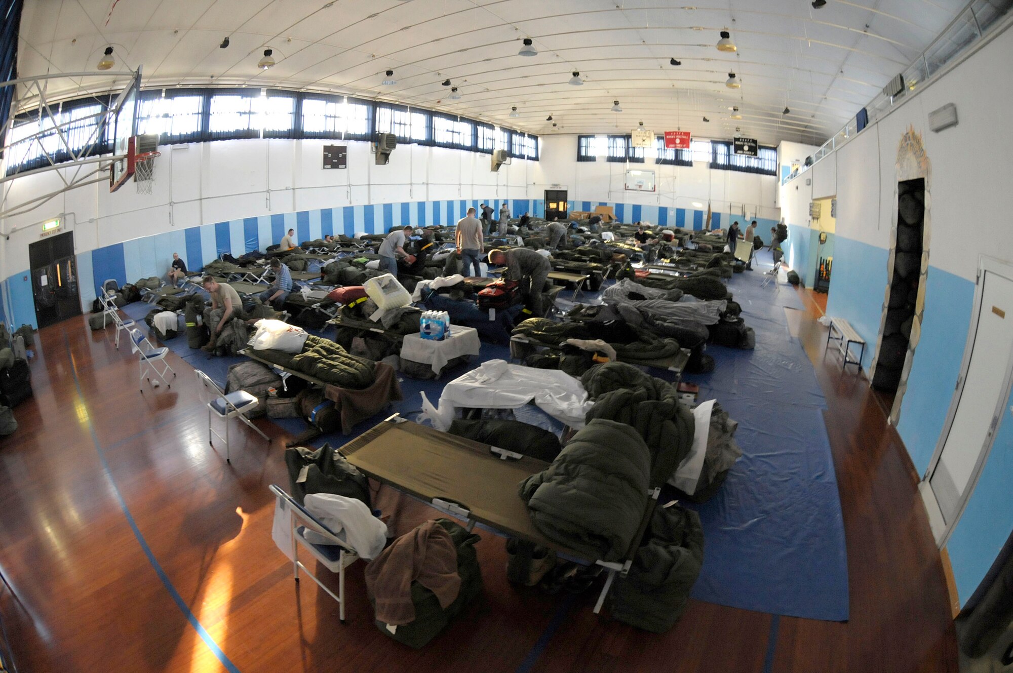 Service members temporarily reside at the fitness center at Aviano Air Base, Italy, March 22, 2011, while deployed there in support of Operation Odyssey Dawn. (U.S. Army photo/Army Staff Sgt. Tierney P. Wilson)