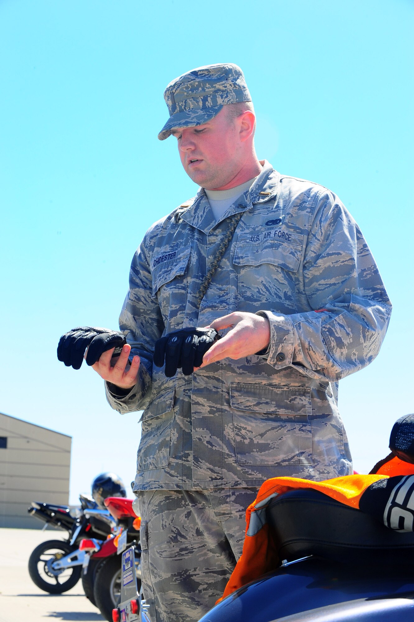 DYESS AIR FORCE BASE, Texas—1st Lt. Michael Chidester, 317th Maintenance Operations Squadron, checks his safety gear March 23 outside Marine Corps Detachment-1 prior to a 317th Airlift Group sponsored motorcycle ride here. Participants included members from the Green Knights Chapter 63, a military motorcycle club specifically for Dyess Airmen, dependents, DoD civilians and retirees. Riders received safety inspections, briefs and participated in a 40-minute ride. The reason for this ride was to highlight the practical application of proper safety gear, defensive riding and riding through different types of terrain. For more information on safety regulations refer to AFI 91-207, The U.S. Air Force Traffic Safety Program, or for more information on the Green Knights, log on to www.texasgreenknights.org. (U.S. Air Force photo/ Airman First Class Courtney Moses)