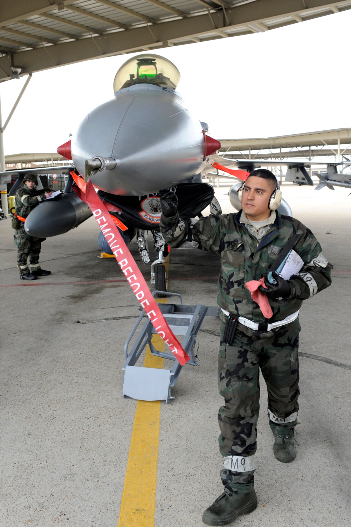 Tech. Sgt. Mike Vigil, crew chief in the 419th Aircraft Maintenance Squadron, completes his part of preflight preparations before an F-16's participation in the ORI on March 20. The two fighter wings recently passed their ORI with a "satisfactory" rating. The rating was the highest achievable for a re-inspection. (U.S. Air Force photo by Todd Cromar)