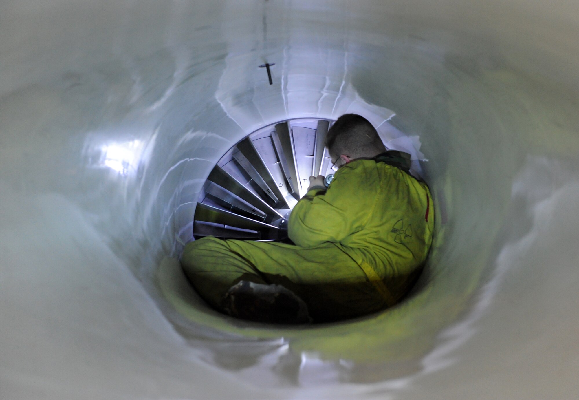Working in the confined space of the engine nacelle, Staff Sgt. Jeffery Dehaan, of the 388th Fighter Wing, inspects the fan blades on an F-16 Fighting Falcon engine on the evening of March 19 during an Operational Readiness Inspection.