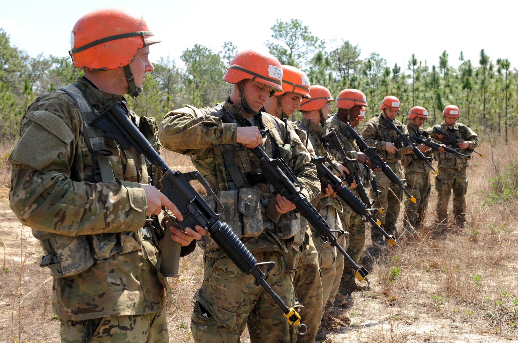 U.S. Air Force Tactical Air Control Party candidates from Falcon Flight 86 are given instructions on how to handle their weapons during a field training exercise, Eglin Air Force Base Range, Fla., March 10, 2011. The week-long FTX is the culmination of everything Falcon Flight 86 has learned thus far in training, testing the class both physically and mentally. (U.S. Air Force photo by Airman 1st Class Caitlin O'Neil-McKeown/RELEASED)

