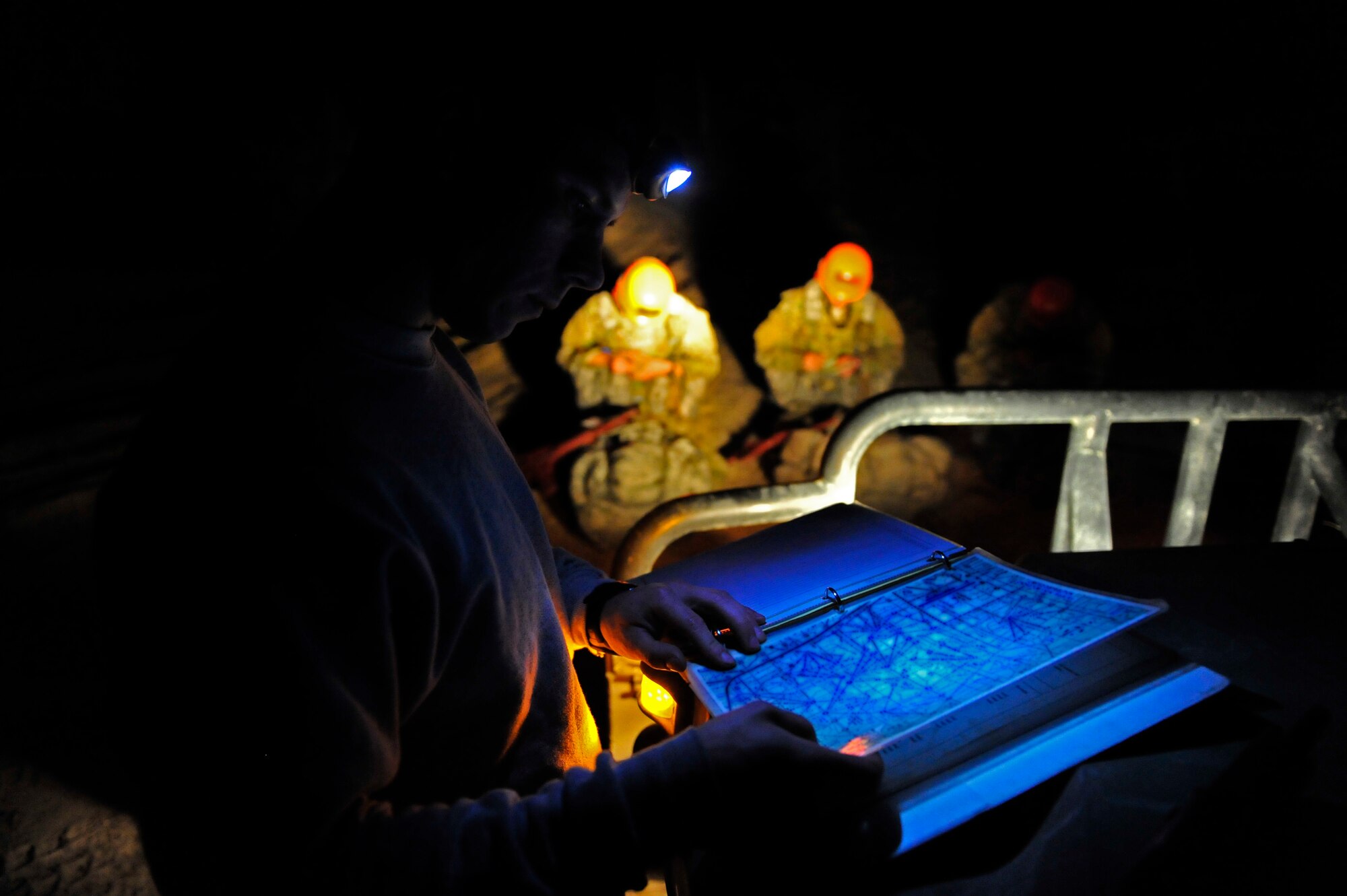 Senior Airman Luke Barckett, U.S. Air Force Tactical Air Control Party instructor, double checks his teams coordinates before sending them out on their night navigation evaluation during a field training exercise, Eglin Air Force Base Range, Fla., March 8, 2011. The week-long FTX is the culmination of everything Falcon Flight 86 has learned thus far in training, testing the class both physically and mentally. (U.S. Air Force photo by Staff Sgt. Stephanie Jacobs/RELEASED)
