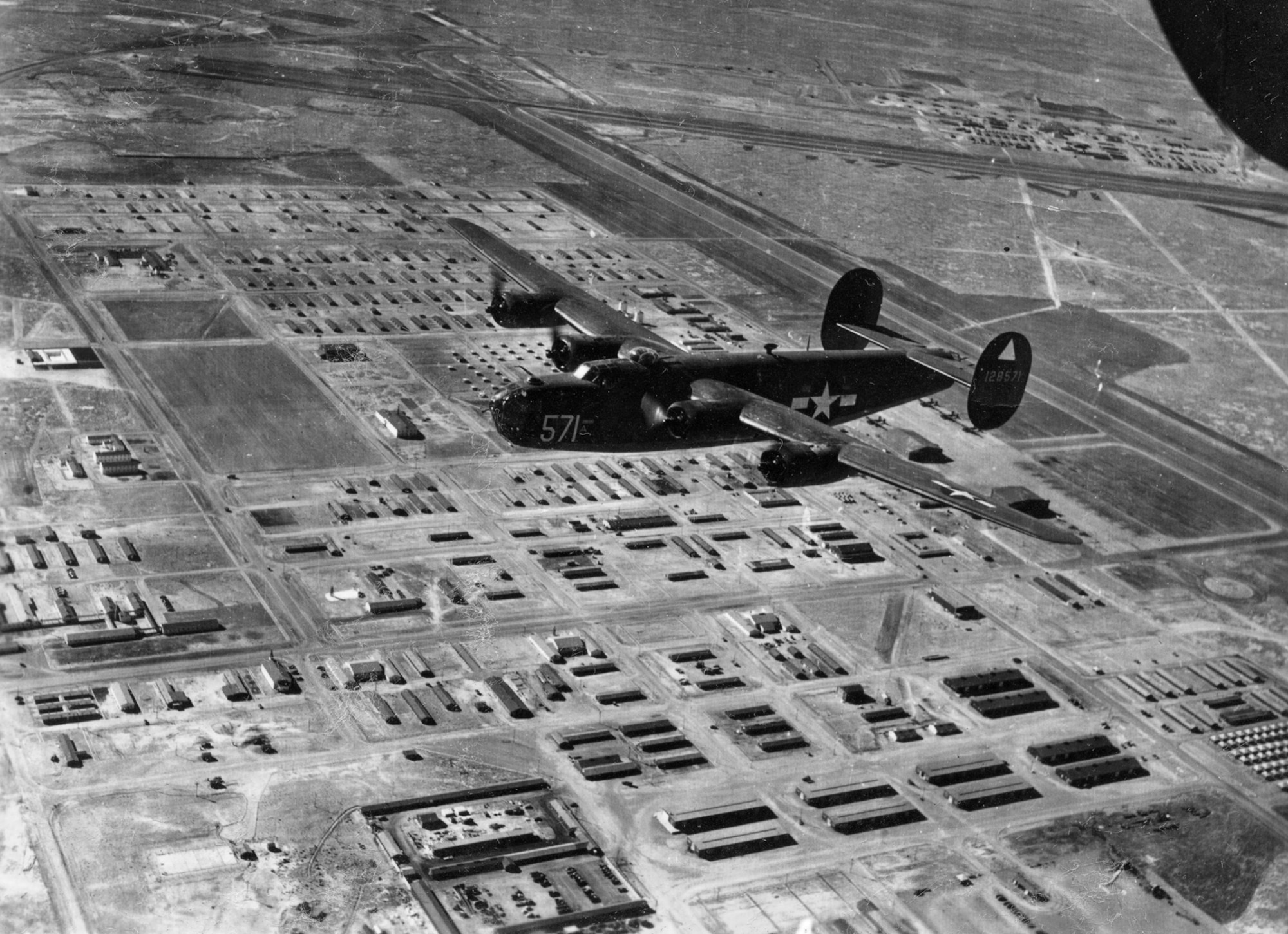 A B-24 flies over Alamogordo Army Air Field, now Holloman Air Force Base, during the 1940s. The airfield served as a training site for 19 bombardment groups and 73 bombardment squadrons flying B-24s and B-29s.The open airspace of 38 miles wide and 64 miles long between the Sacramento, Organ and San Andres Mountains were a bonus for the increased training required by the Army Air Forces. (photo courtesy of 49th Wing History Office) 