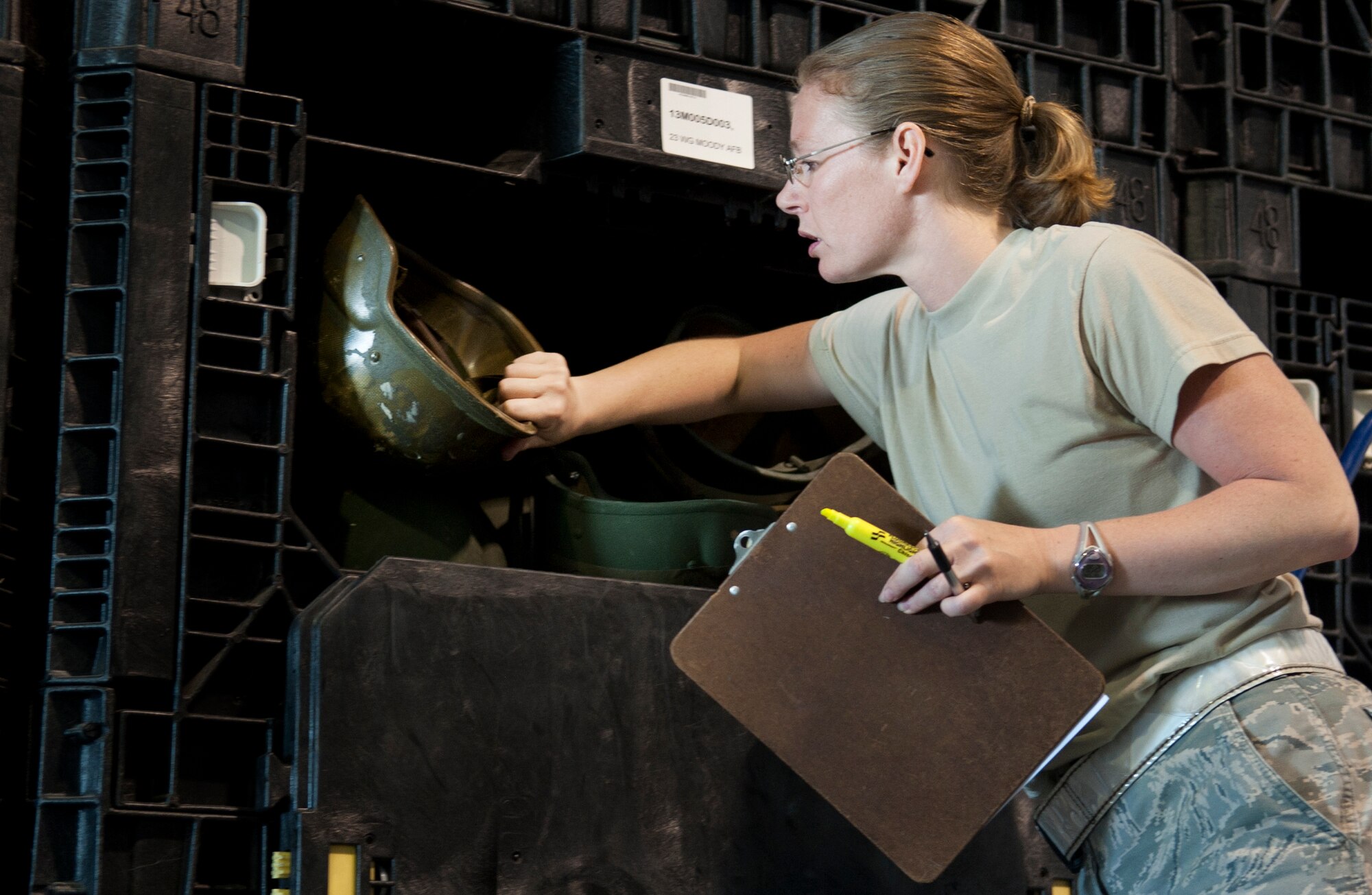 MOODY AIR FORCE BASE, Ga. -- Tech. Sgt. Brooke Blanton, 23rd Logistics Readiness Squadron assistant NCO in charge, searches for an extra-large helmet during a mass-equipment issue March 24. The 23rd LRS IPE flight issued equipment to more than 200 people today. (U.S. Air Force photo/Airman 1st Class Douglas Ellis)(RELEASED)

